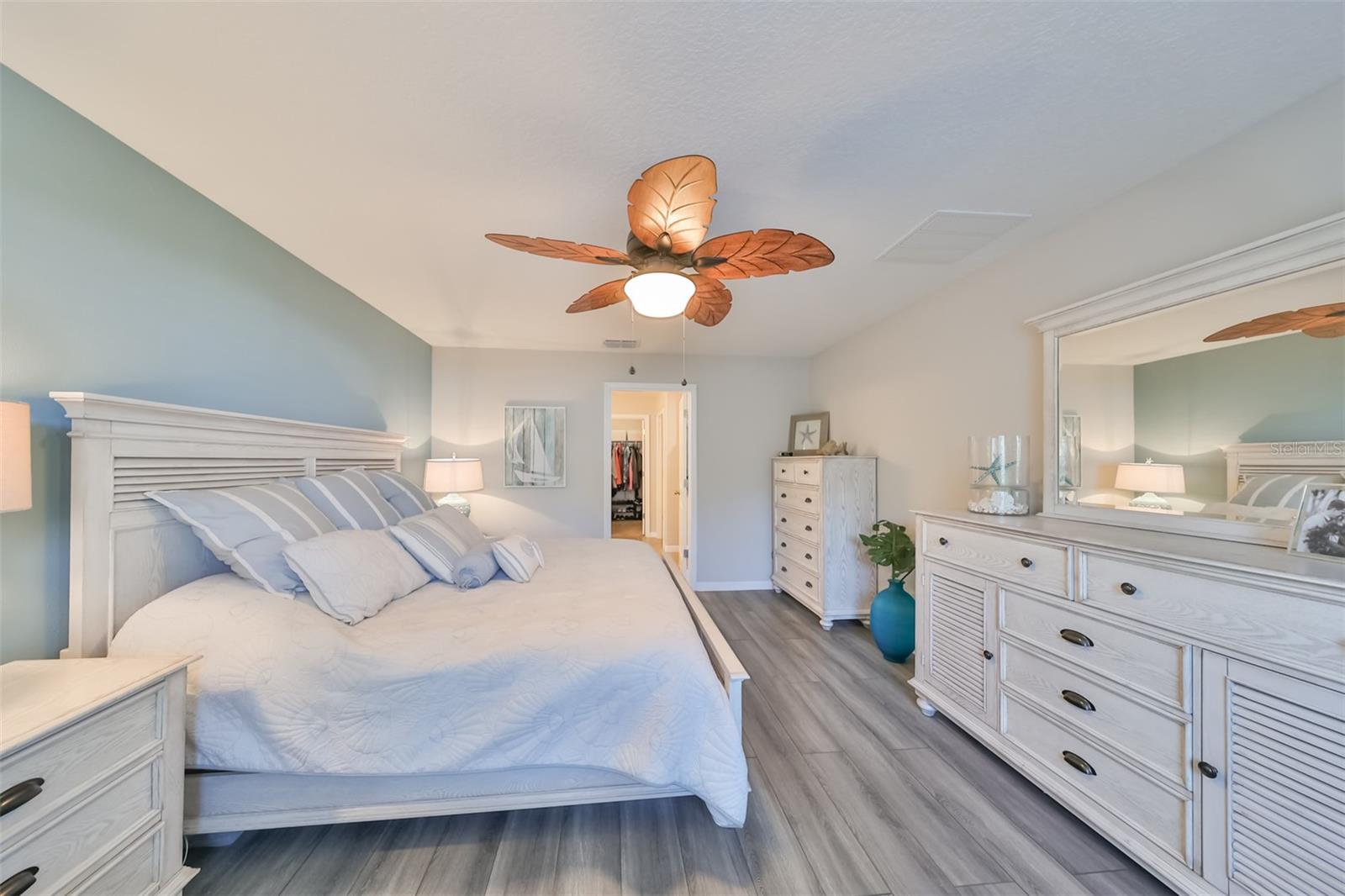 Soft, relaxing paint tones and custom ceiling fan just add to the ambiance.