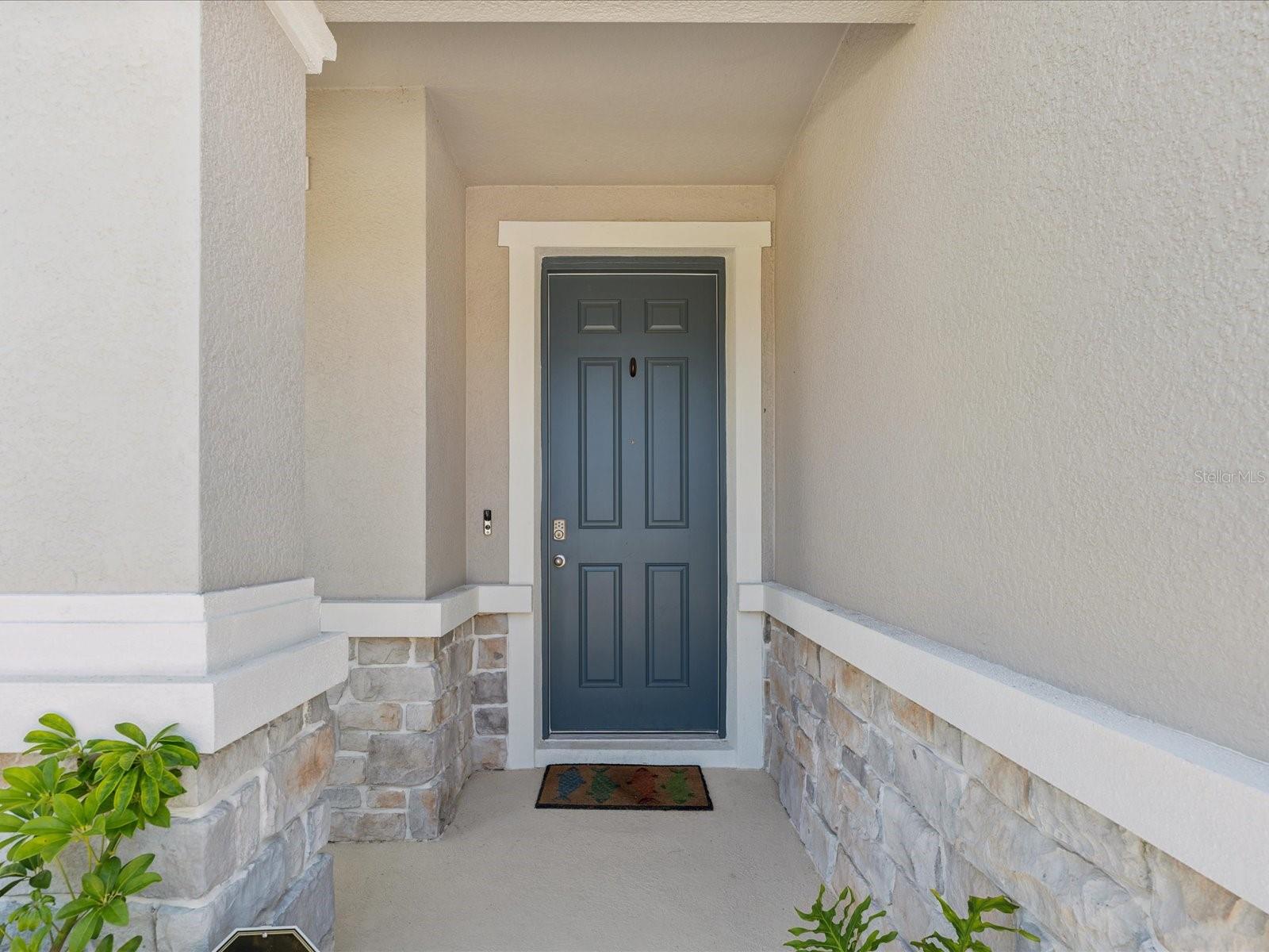 The front door has a covered entryway to protect anyone from the elements.