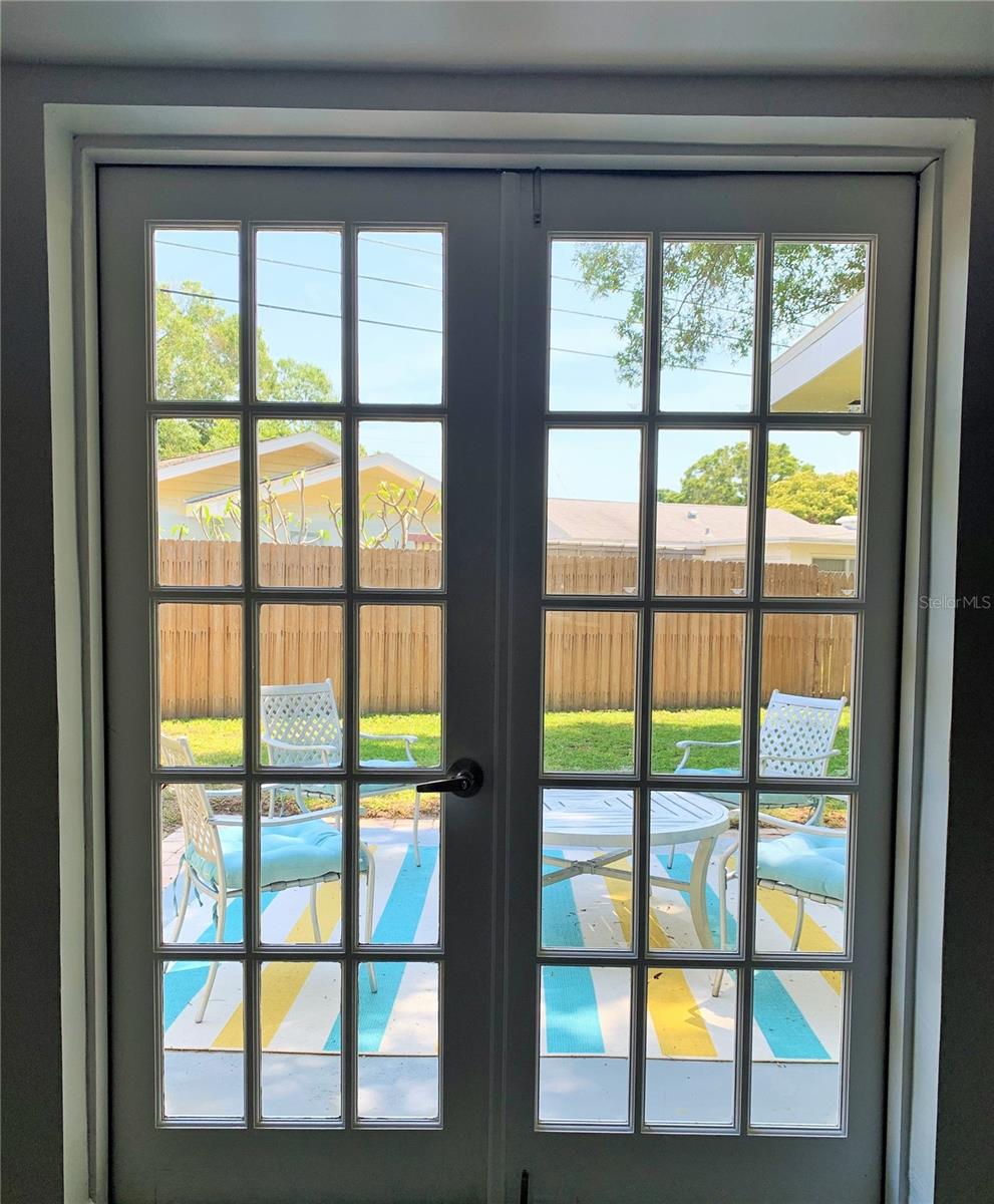 French doors leading to fenced in backyard