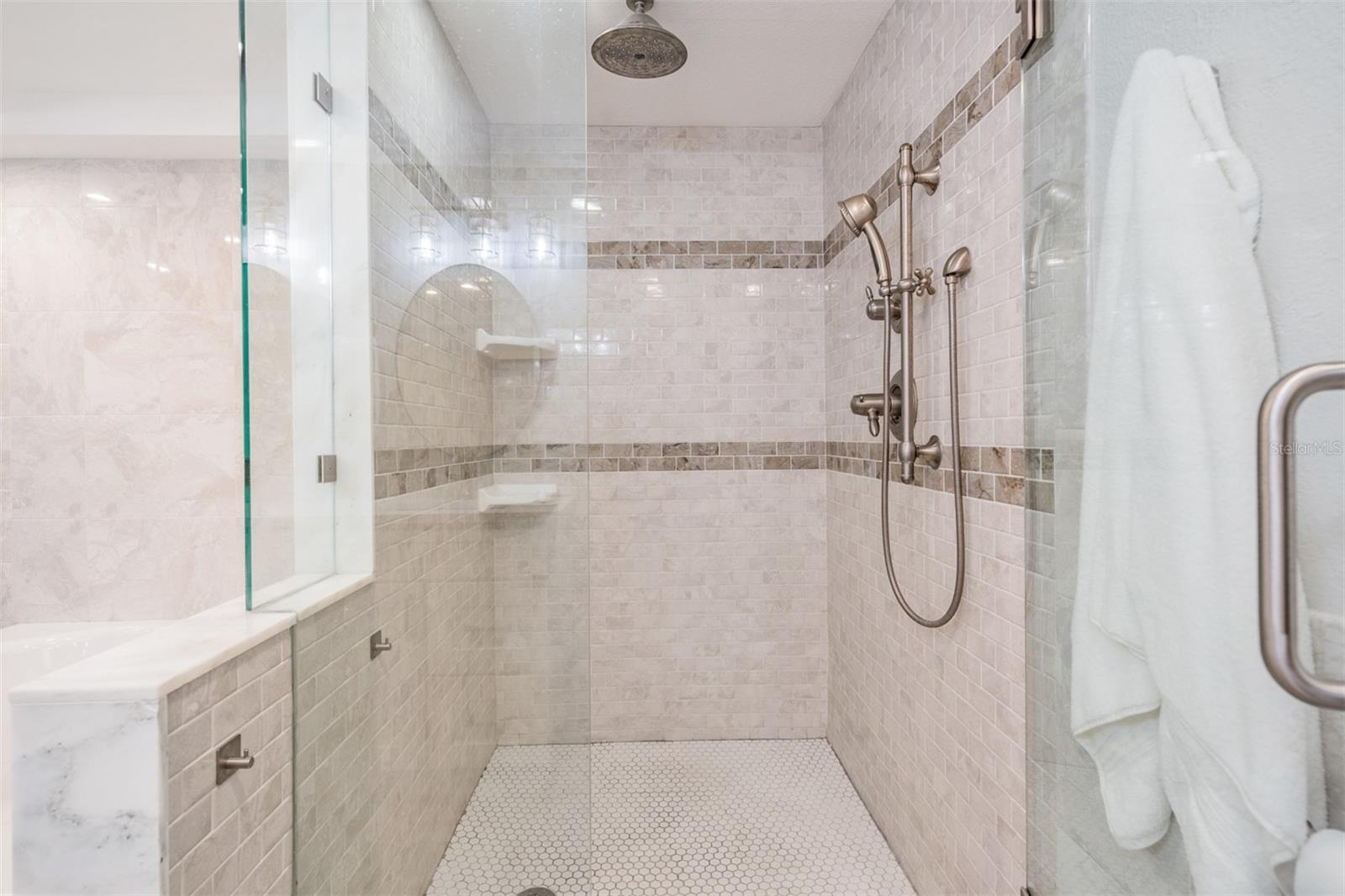 beautifully tiled shower with rainhead