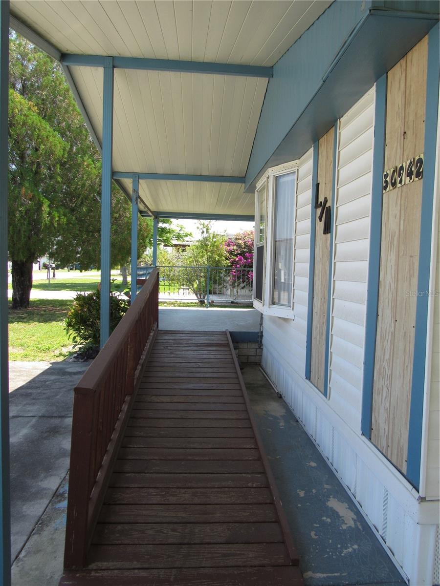 Ramp to covered front porch & raised Florida room entry.
