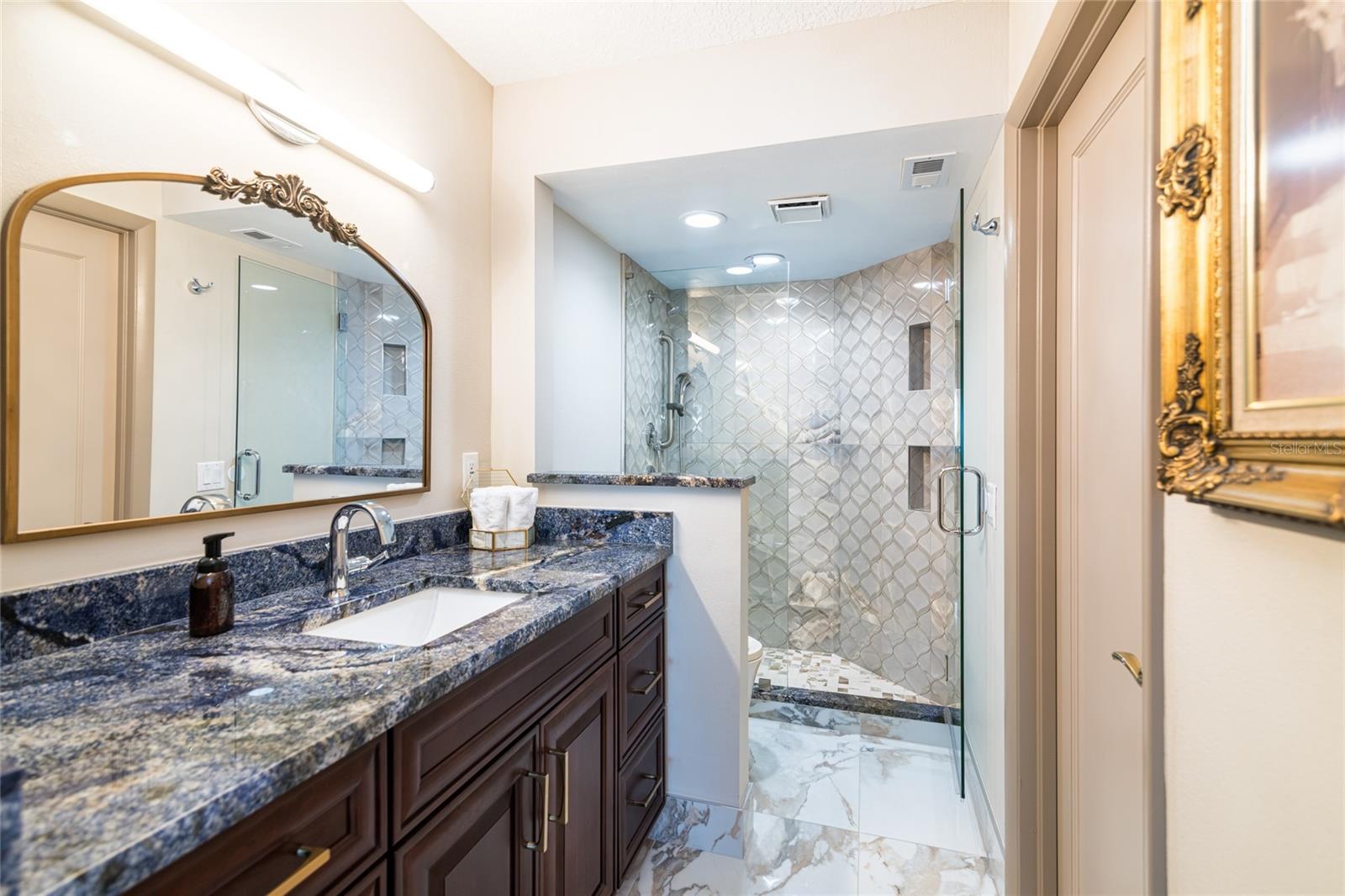 Master bathroom - blue granite counter top and exquisite tile work in the shower and just wait until you see the toilet - it is top of the line!!