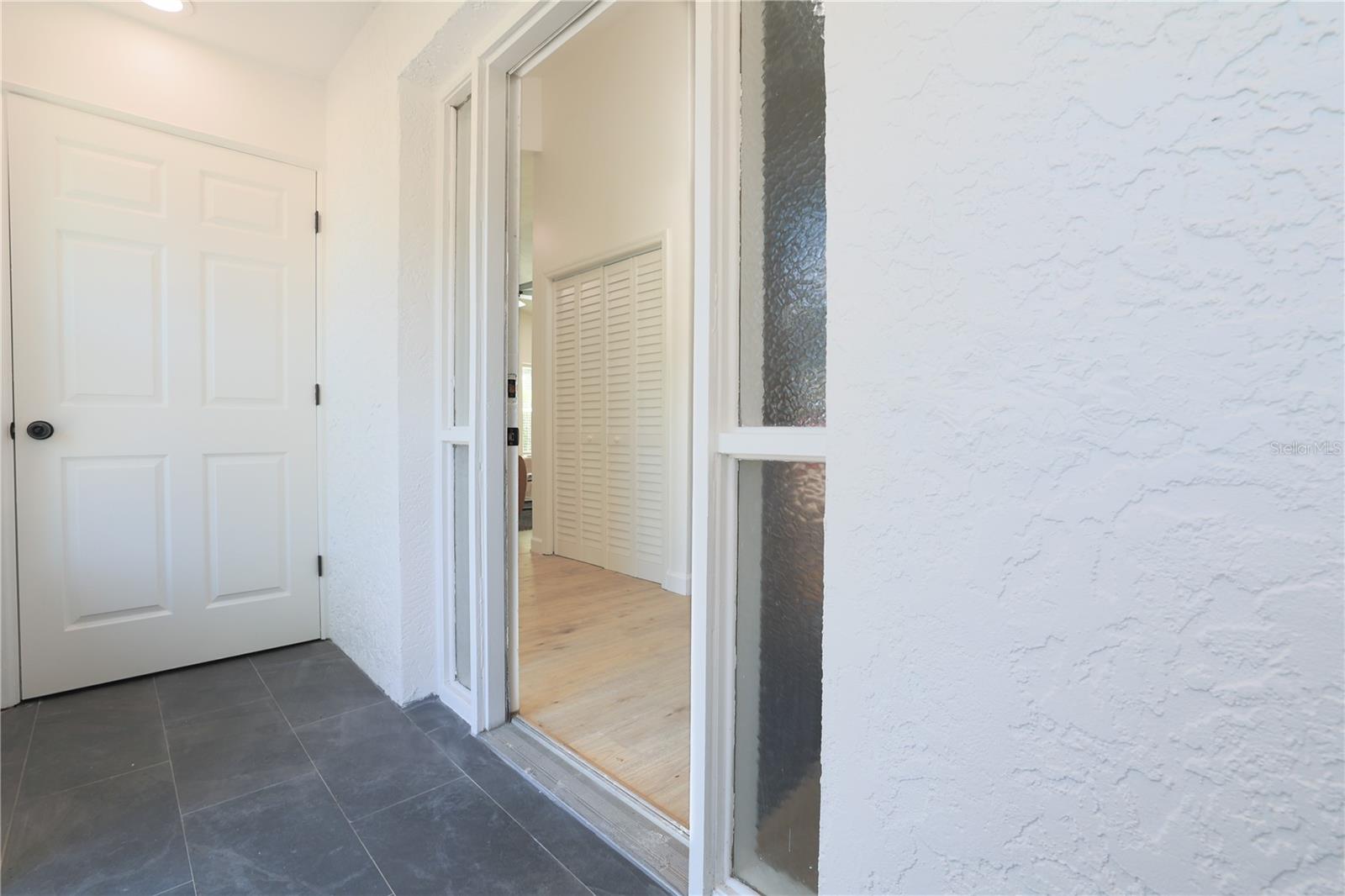 Enclosed front entrance with 2 storage closets