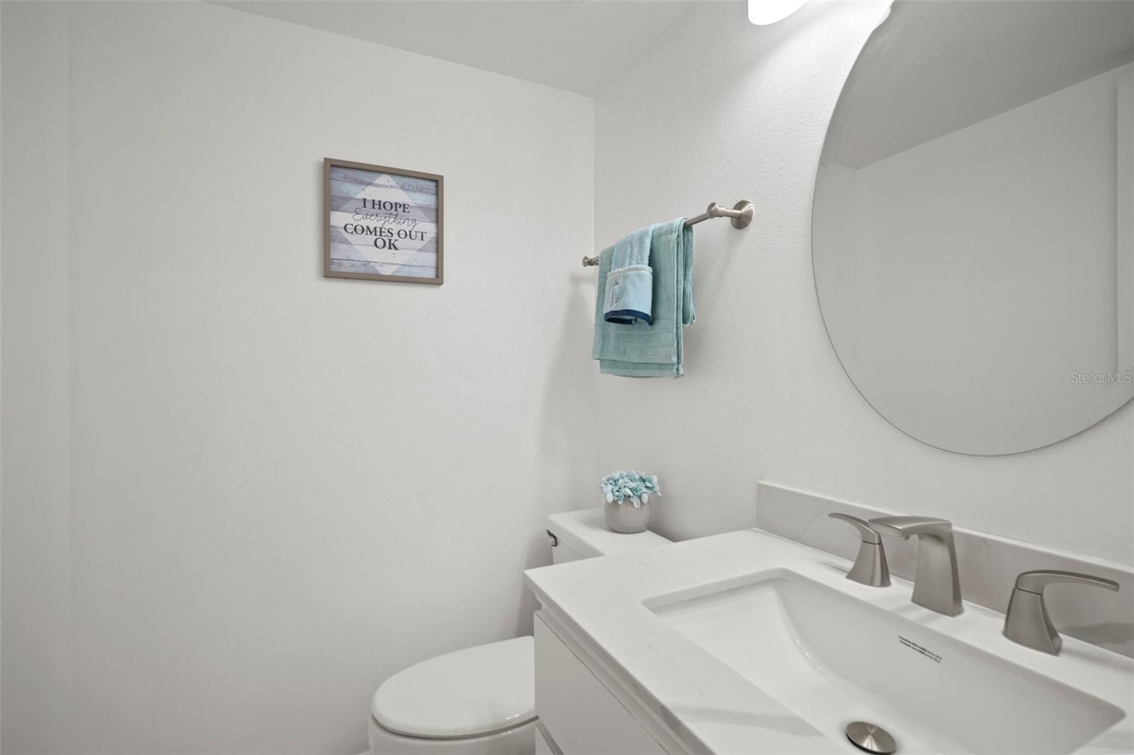 1/2 Bath located between the kitchen and the dining room. Located right at the bottom of the stairs.