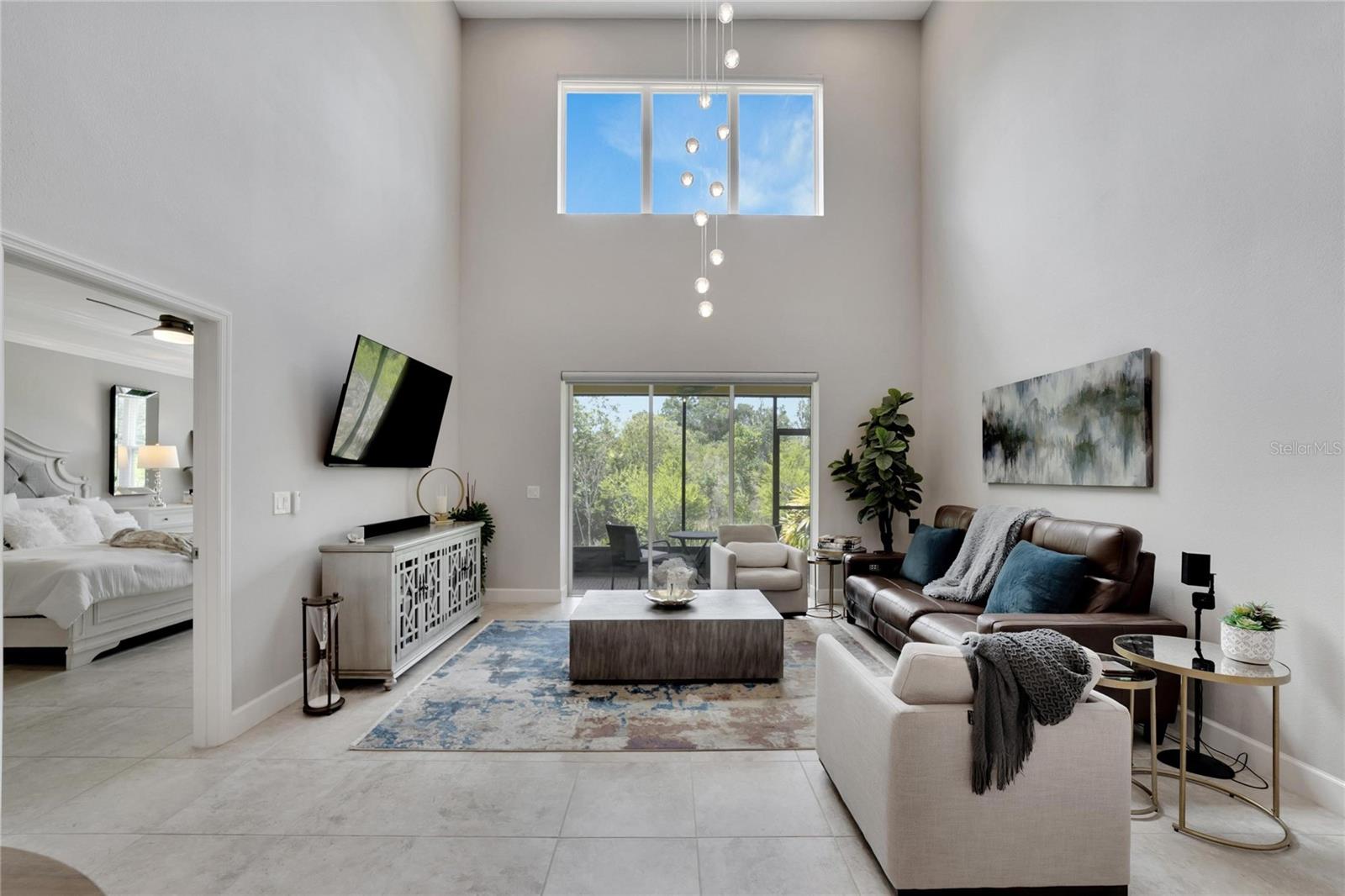 Living Room with HUGE sliding pocket door and tall windows at 12306 Terracina Chase Ct, Tampa, FL 33625