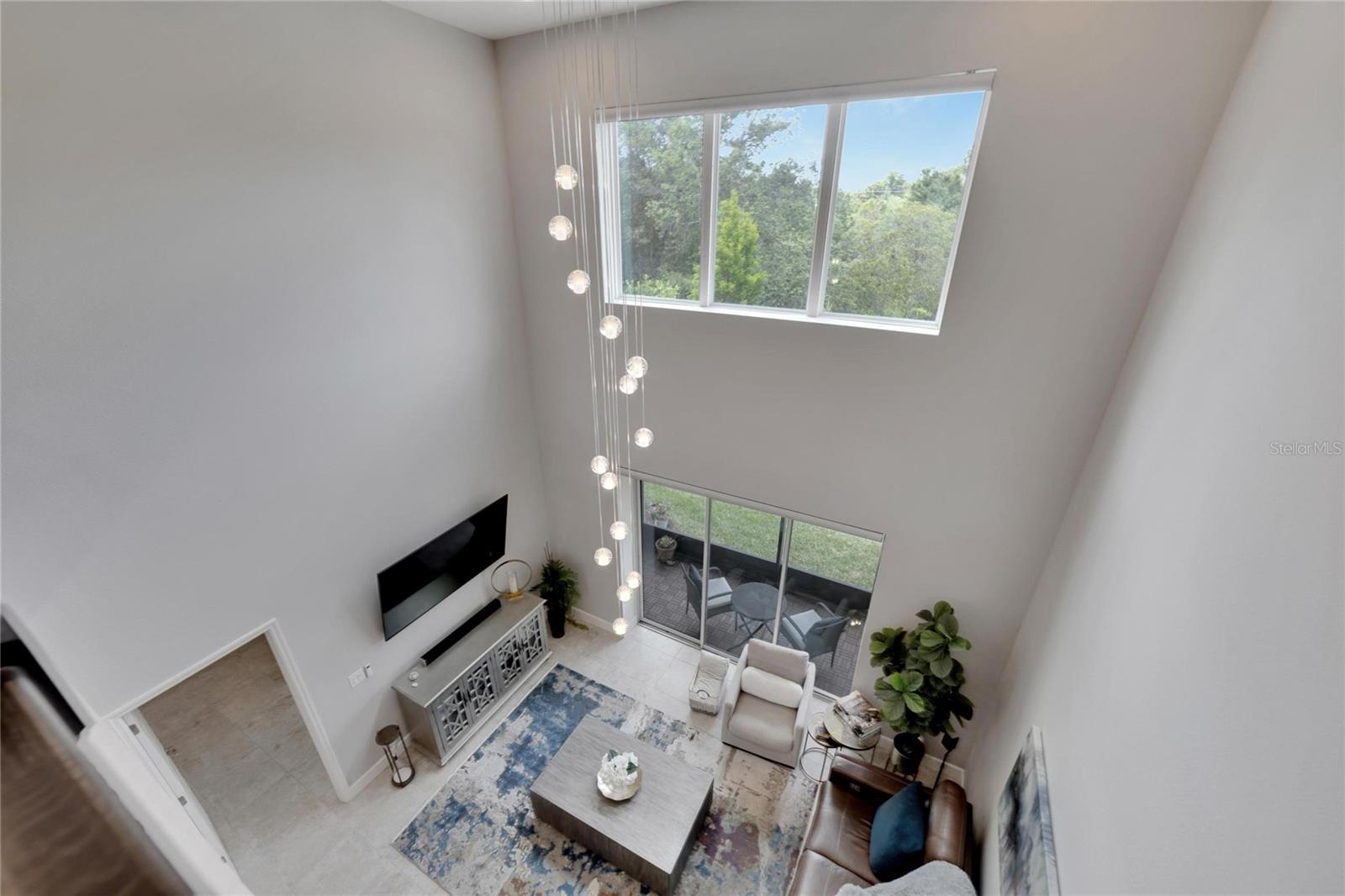 View into living room from loft at 12306 Terracina Chase Ct, Tampa, FL 33625