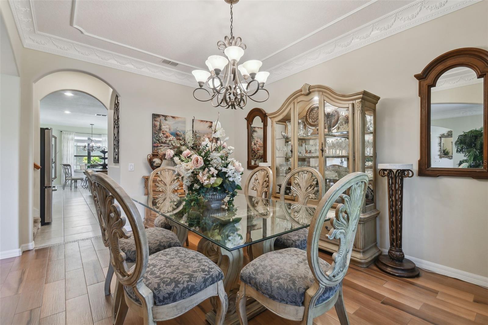 Formal dining room featuring extensive crown moulding