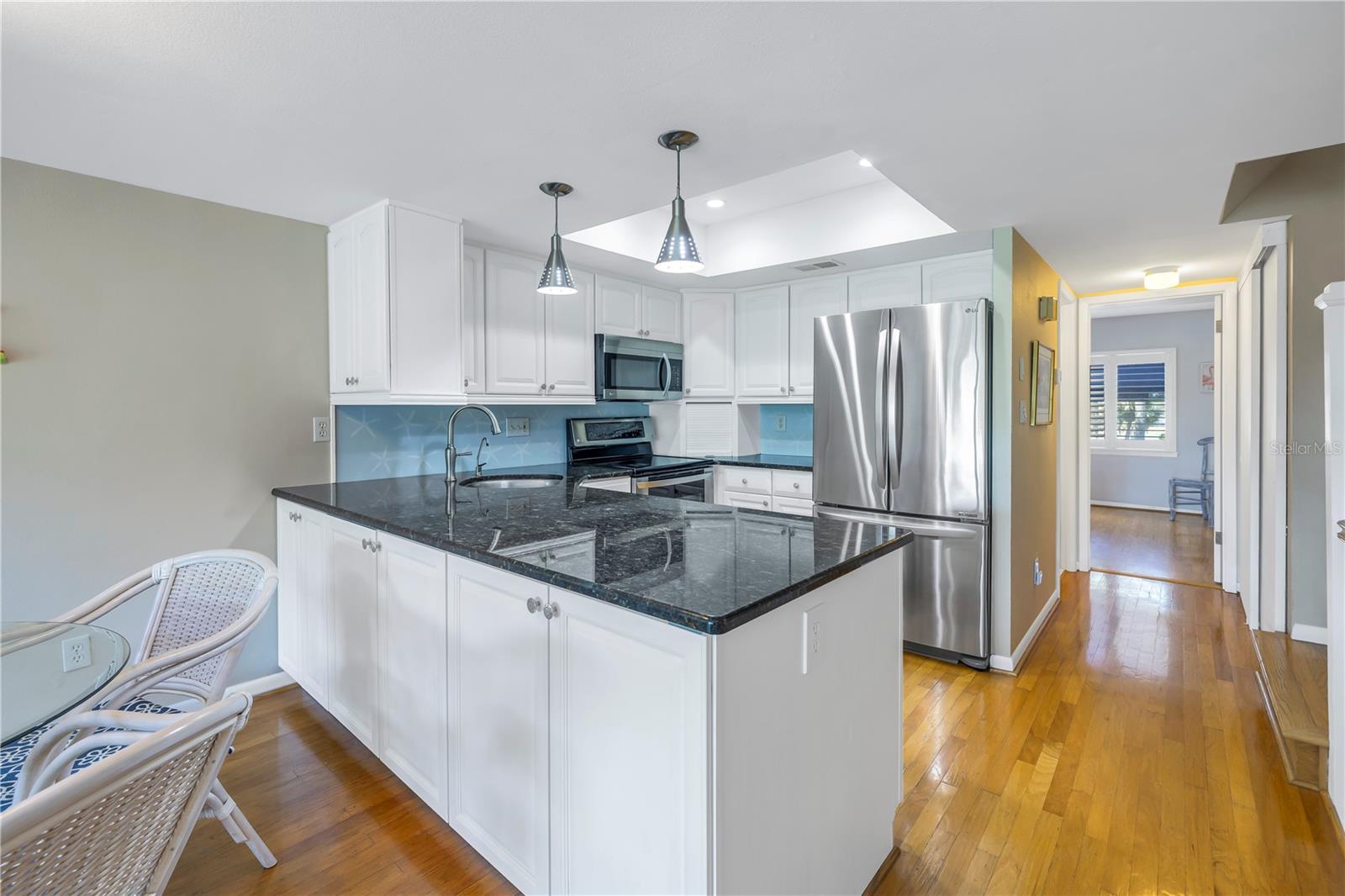 Kitchen is bright with wood cabinets