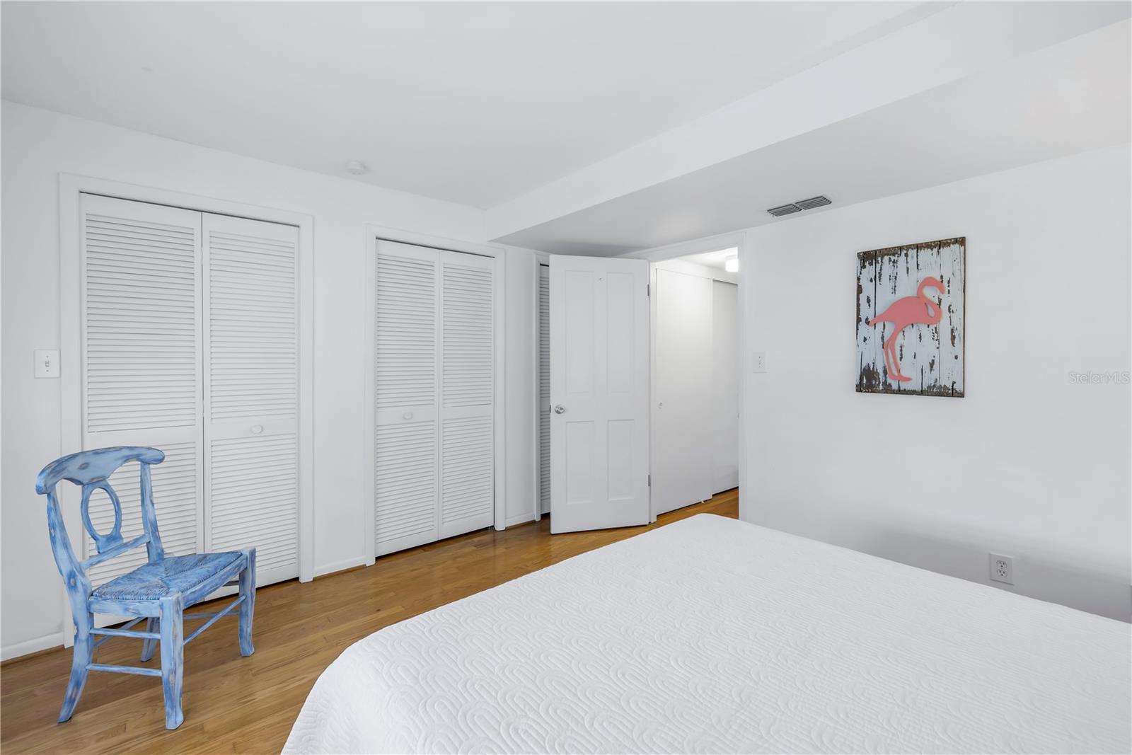 Upstairs is the Primary bedroom with high ceilings, plantation shutters, sliding doors lead to a balcony