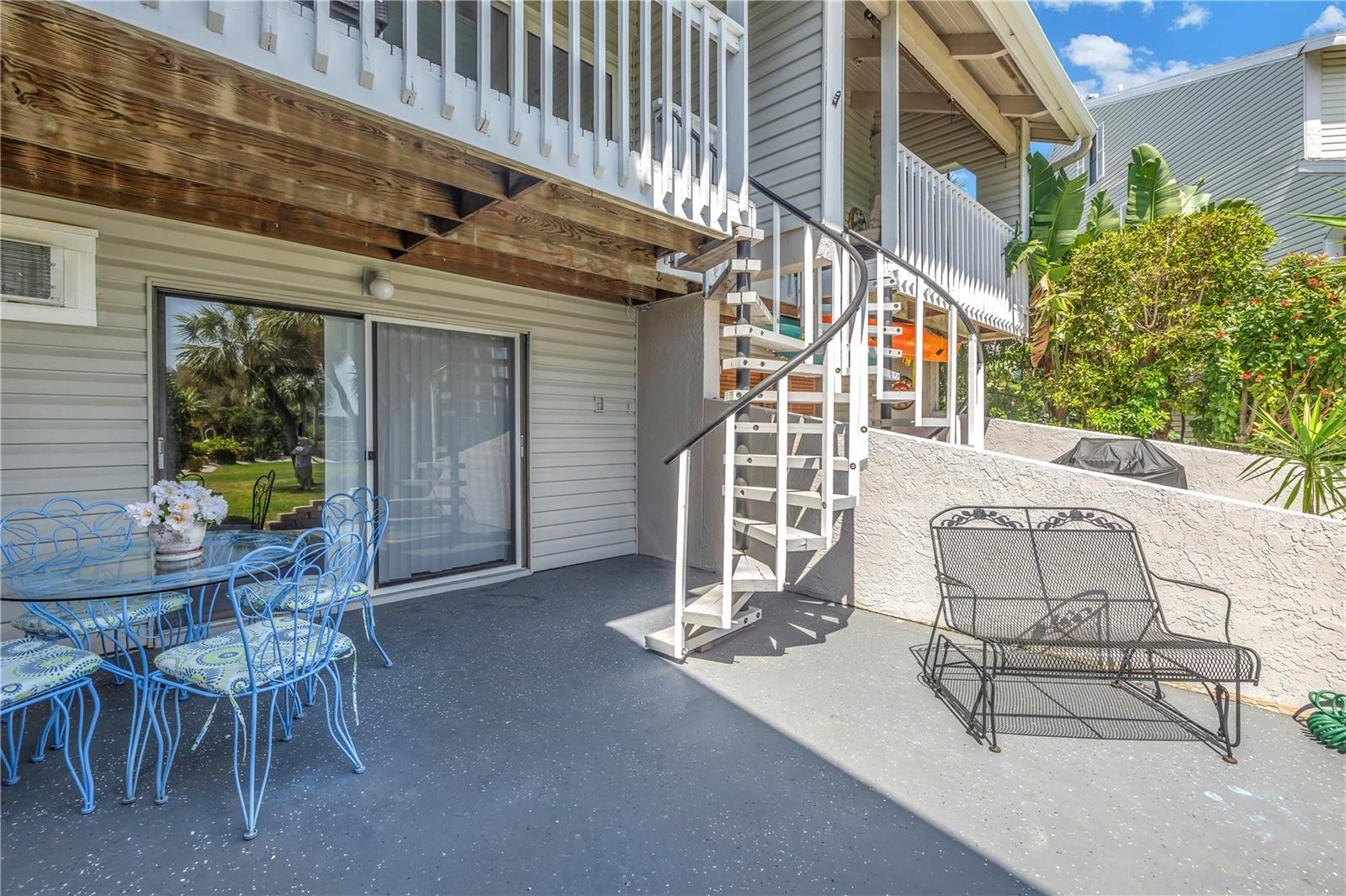 Sliding doors in the bonus room lead to the patio