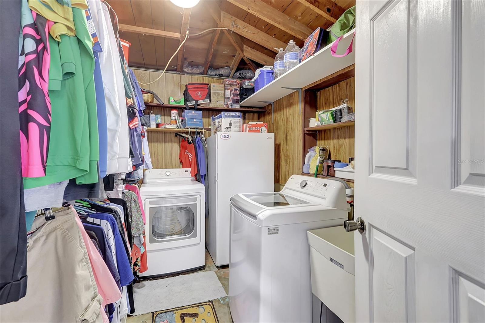 Laundry room, tub and spacious hanging racks