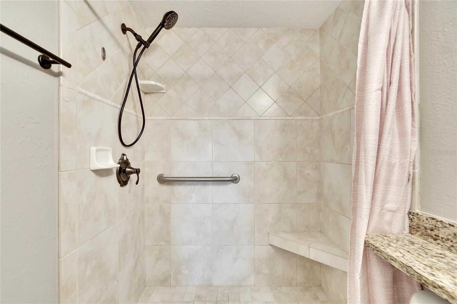 Tile surround in master shower.