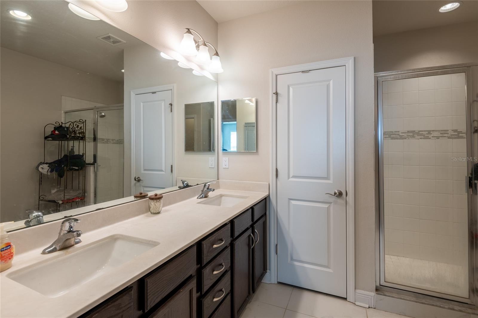 Primary bathroom- Quartz countertops with dual sinks. Also, has dual walk-in closets.
