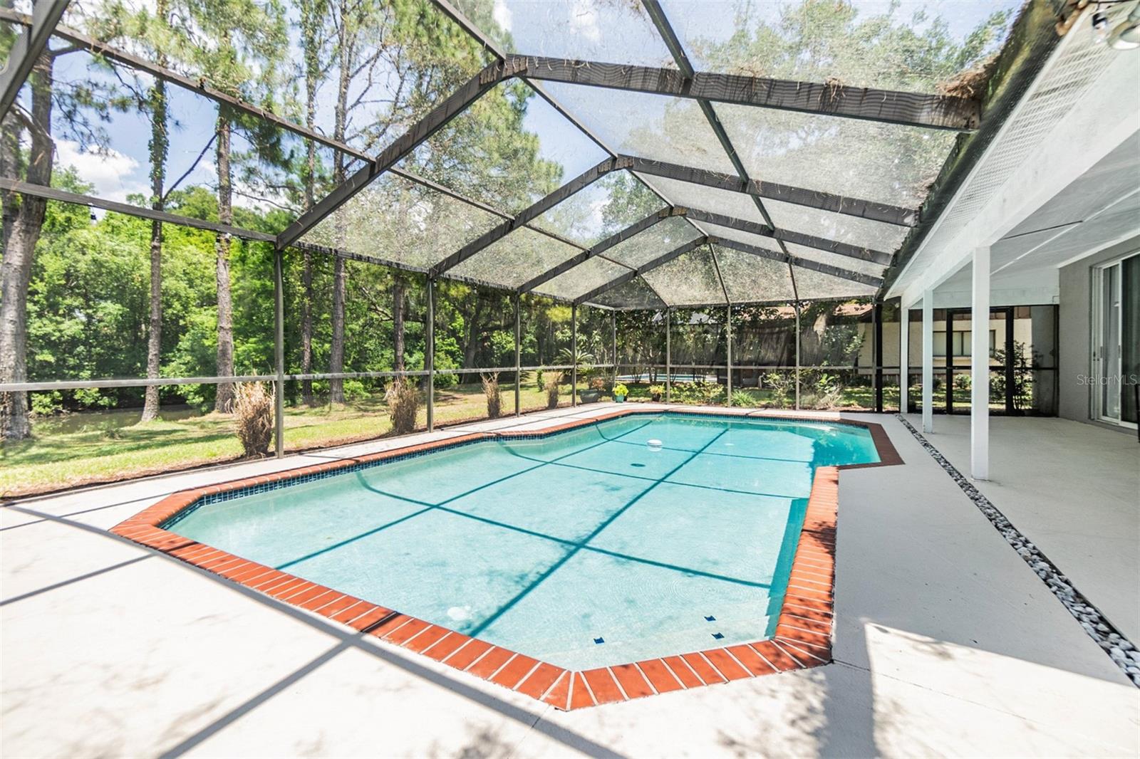 Large screened in pool and undercover areas.