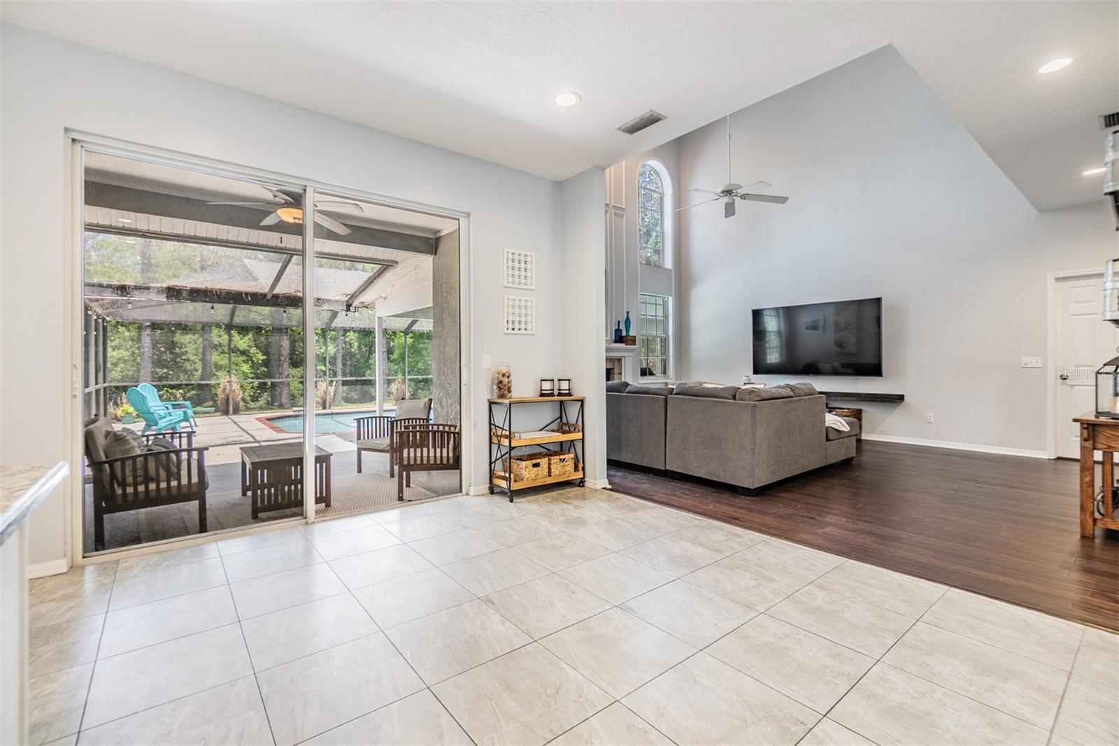 Open space for a Kitchen table that leads into the Family Room, with views of the pool.
