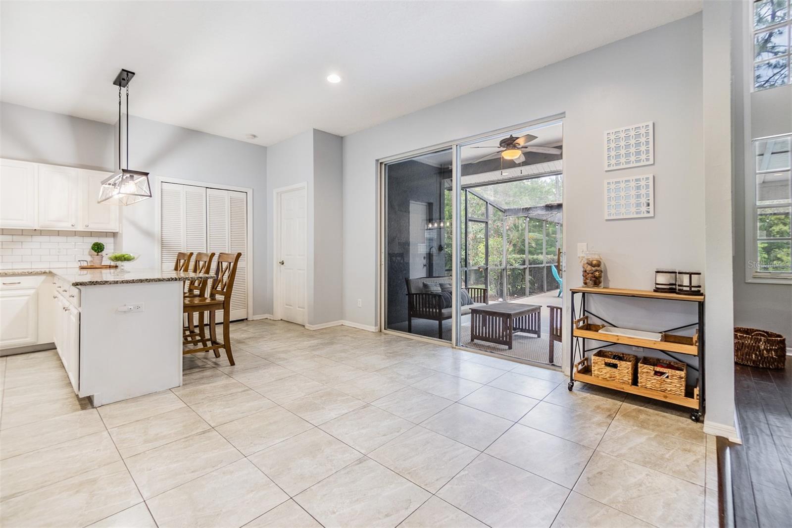 Open space for a Kitchen table that leads into the Family Room, with views of the pool.