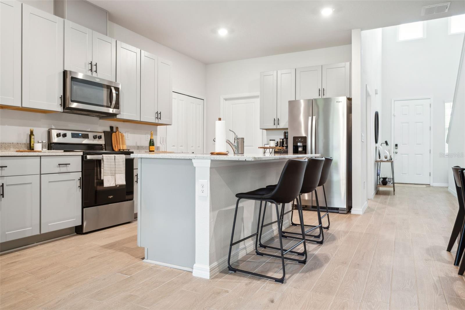Your kitchen features stainless steel appliances, island seating for 4, quartz countertops, and a closet pantry with laundry room access & the garage.