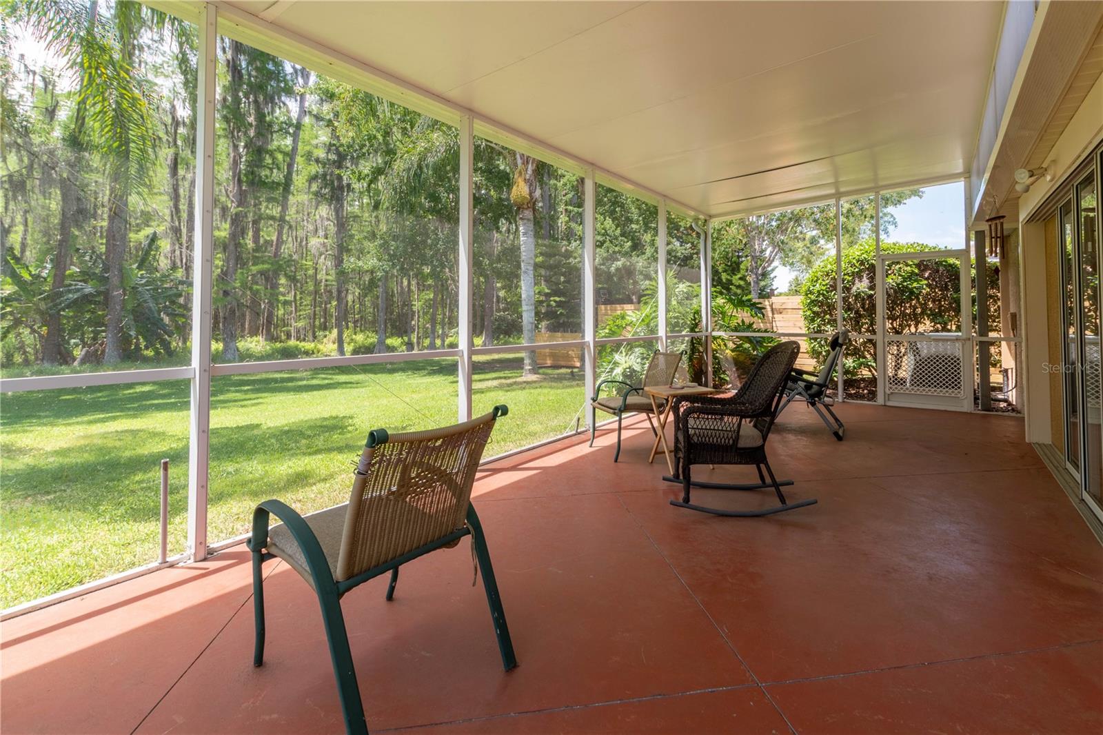 Sit and relax in the Lanai. Watch the view of the lovely backyard.