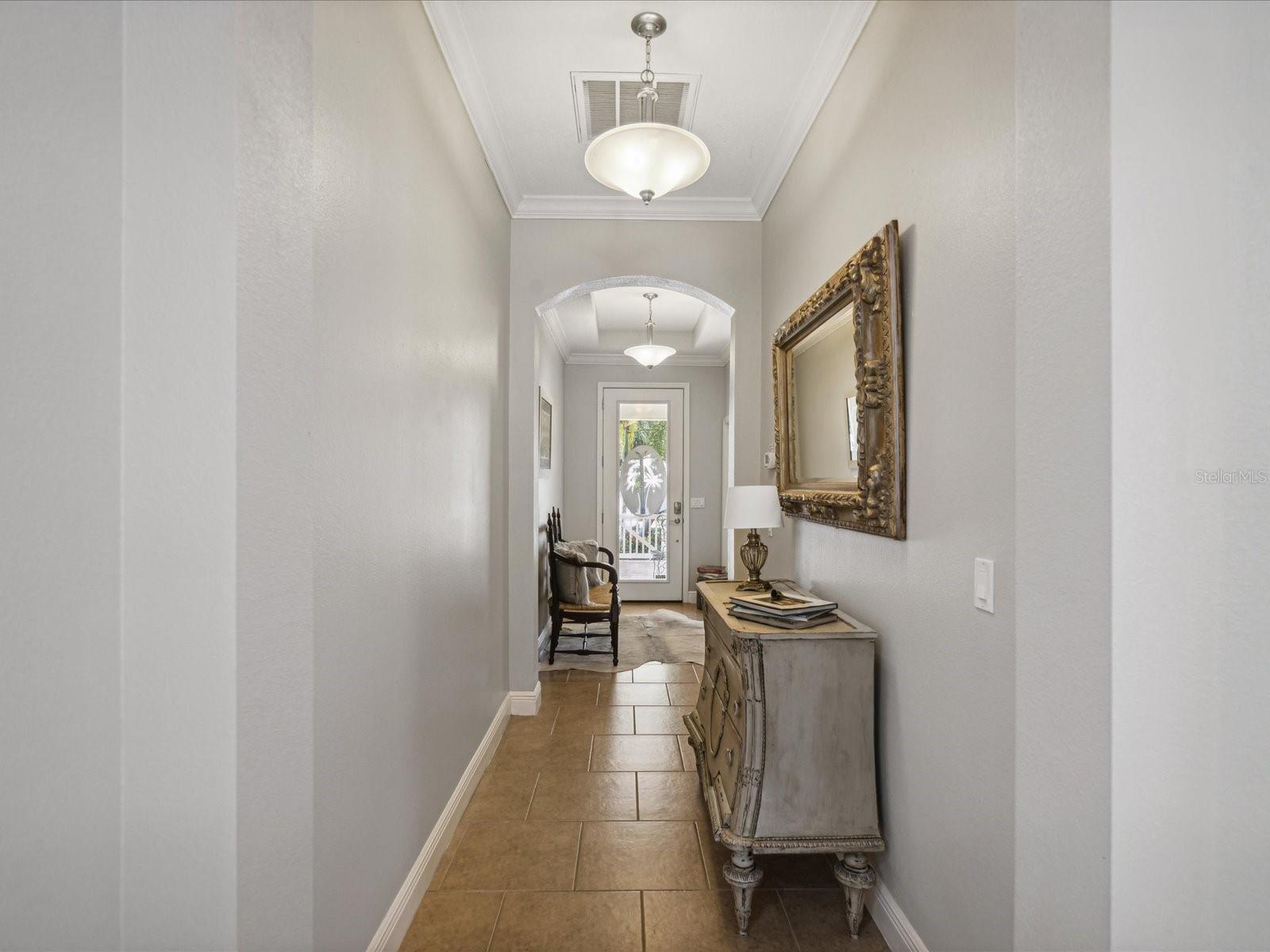 The archway separates the front bedrooms from the rest of the hallway leading to the great room/kitchen and dining area.