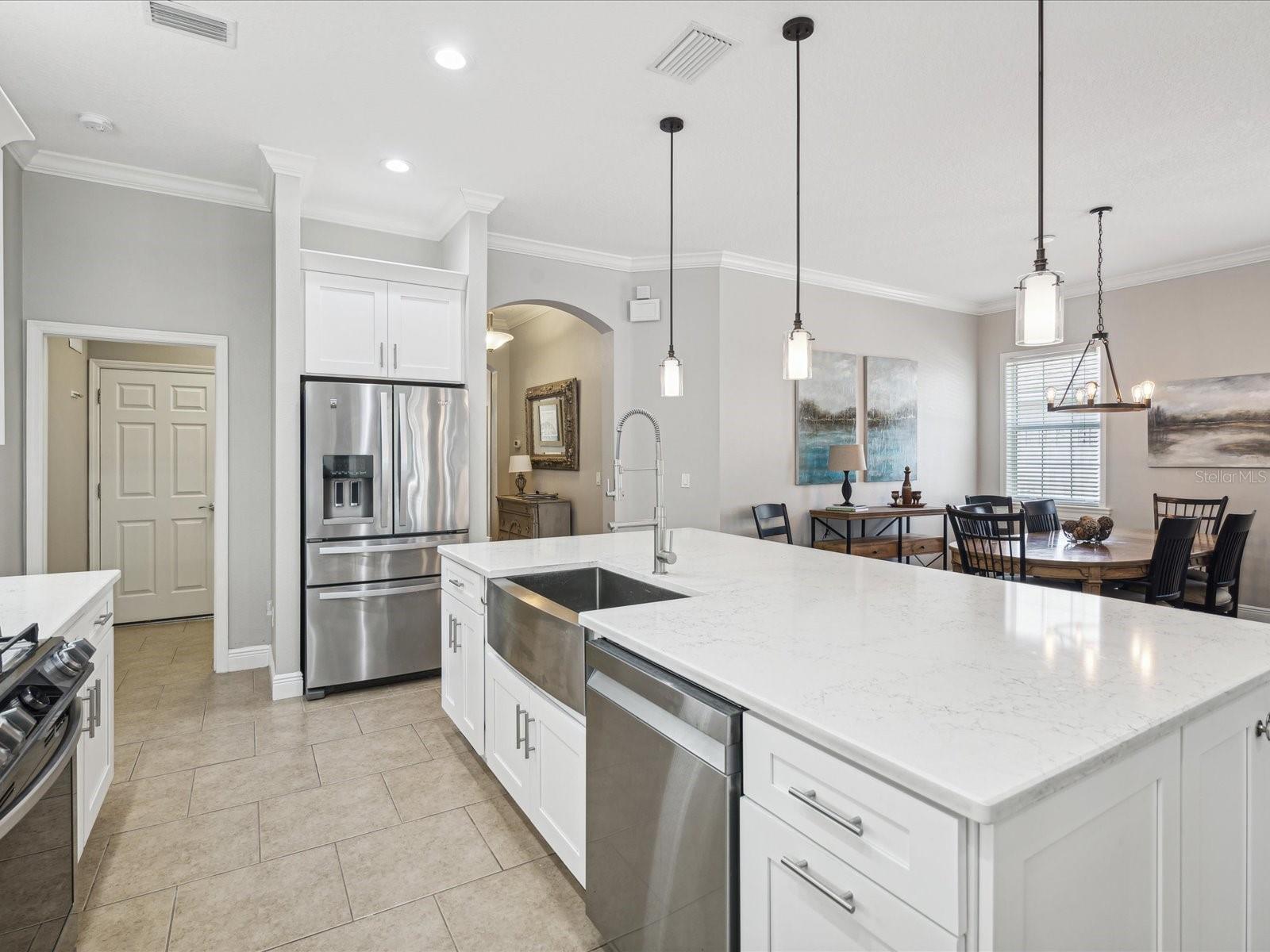 Stainless steel appliances complement the kitchen and add a modern flair to this cottage design.