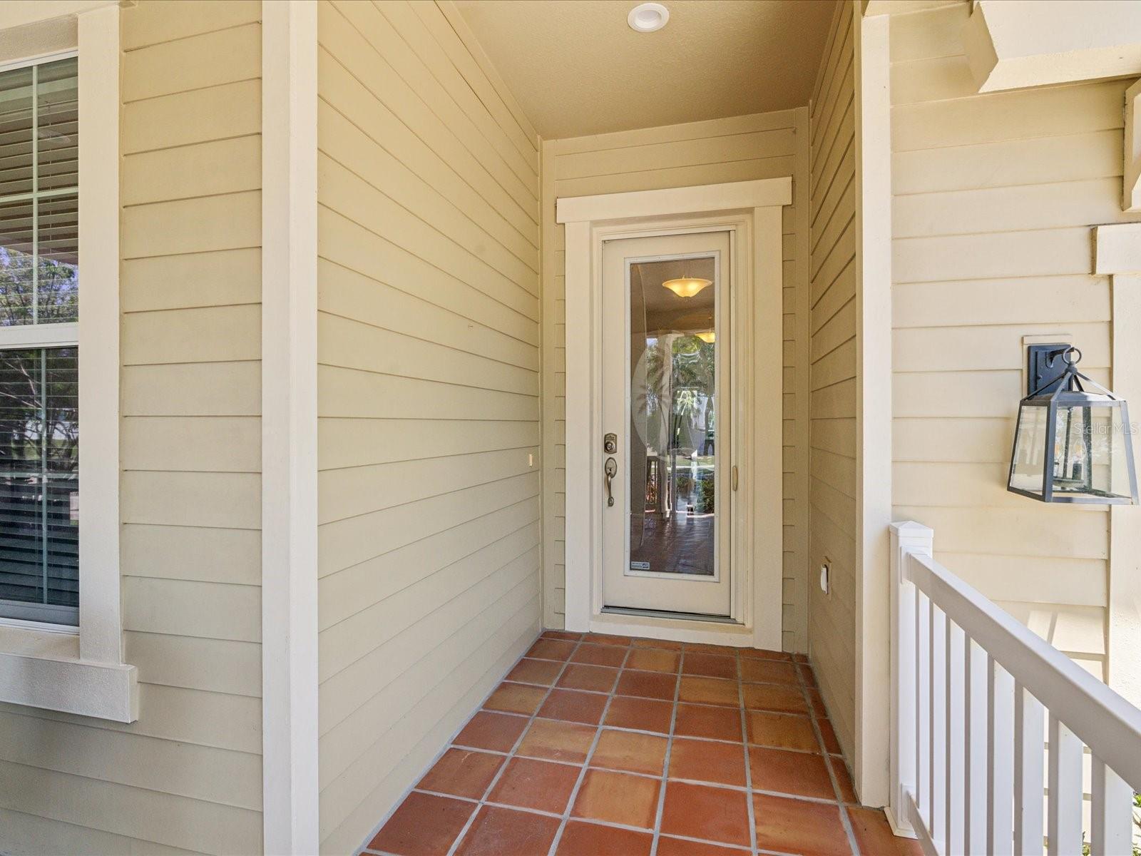 The front door is in its own alcove that protects from the elements.