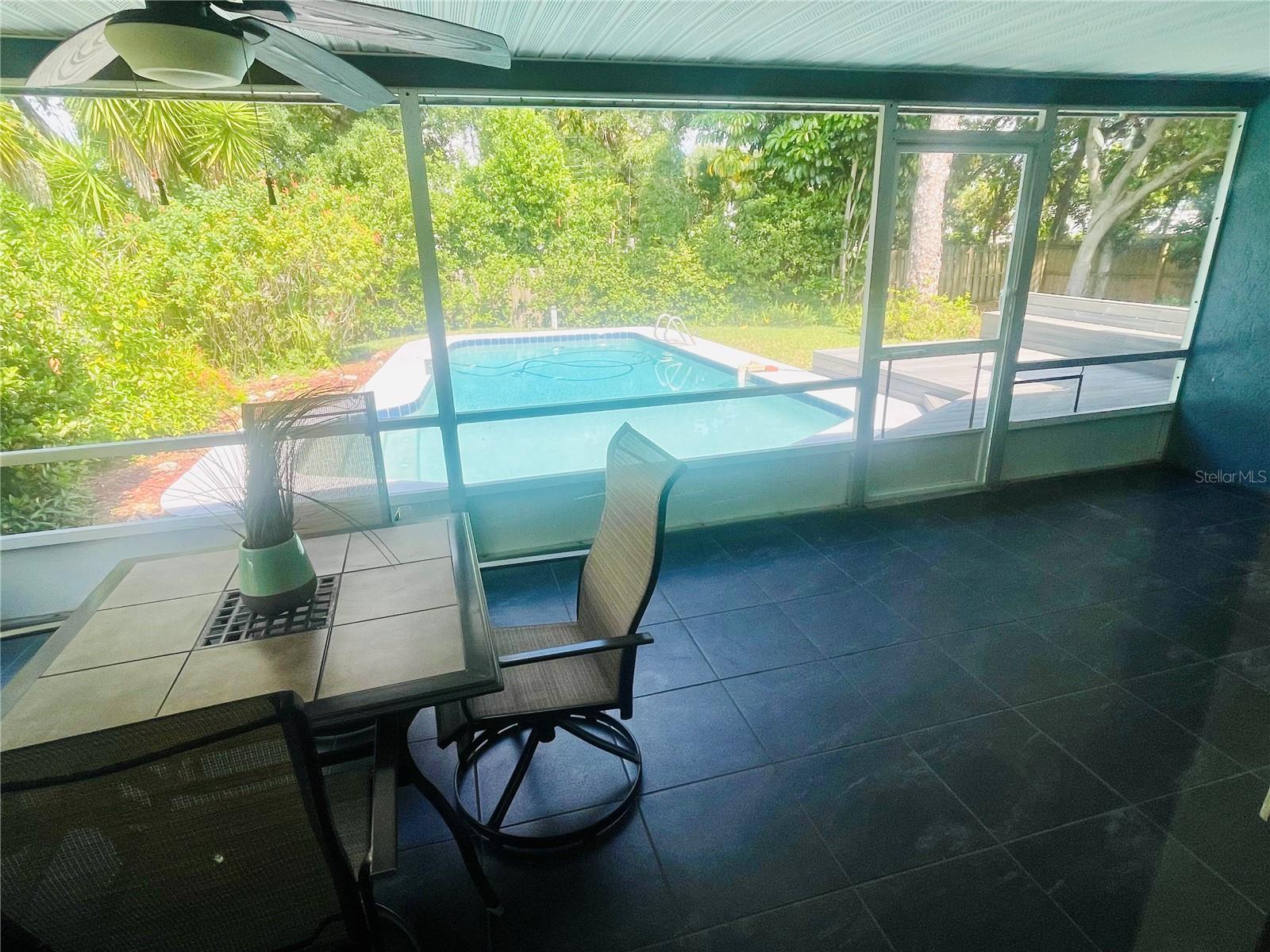 Screened lanai overlooking the pool and superb backyard with room for the dog to run or for a swingset.