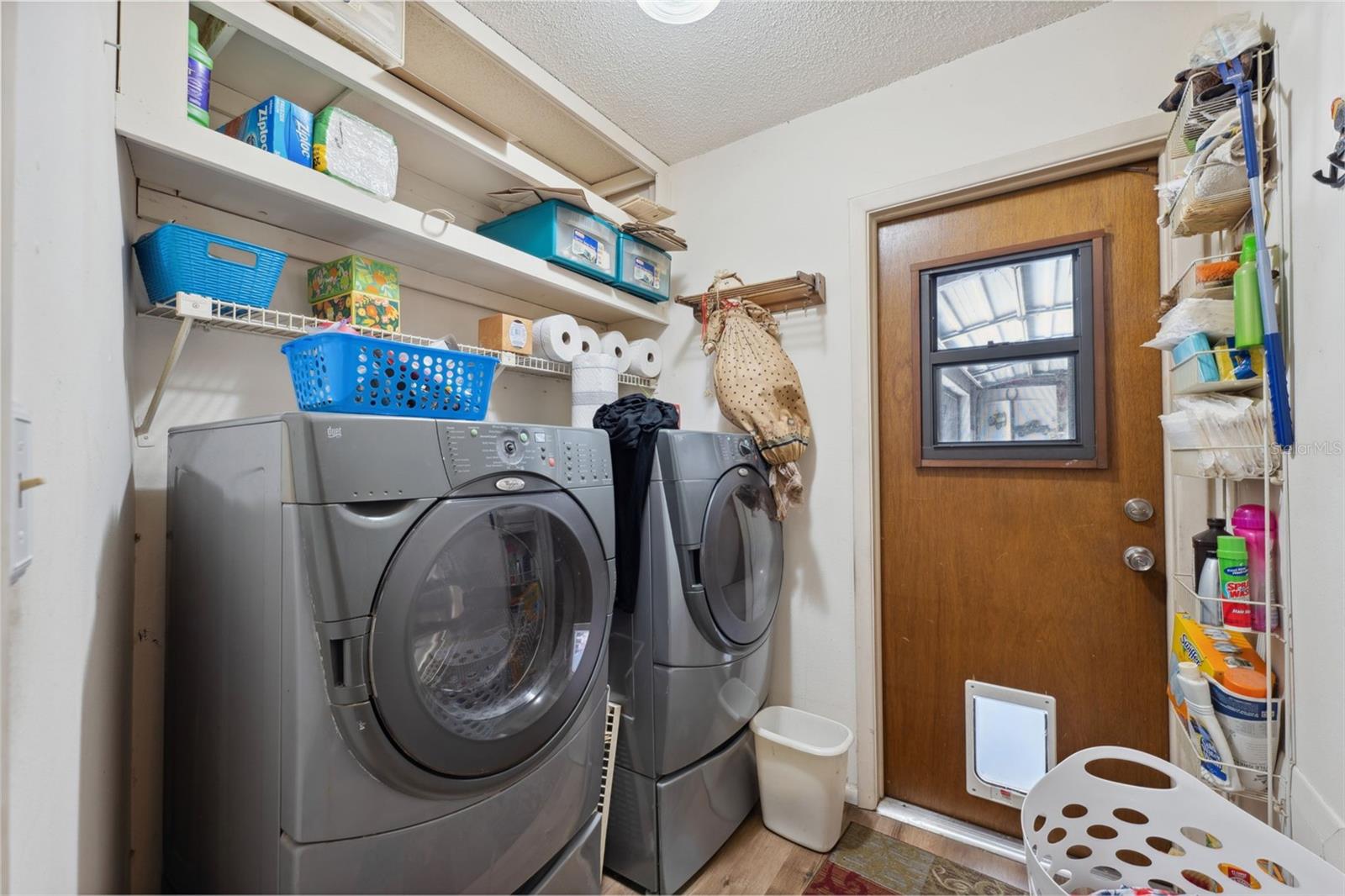 Inside laundry room with ample storage.