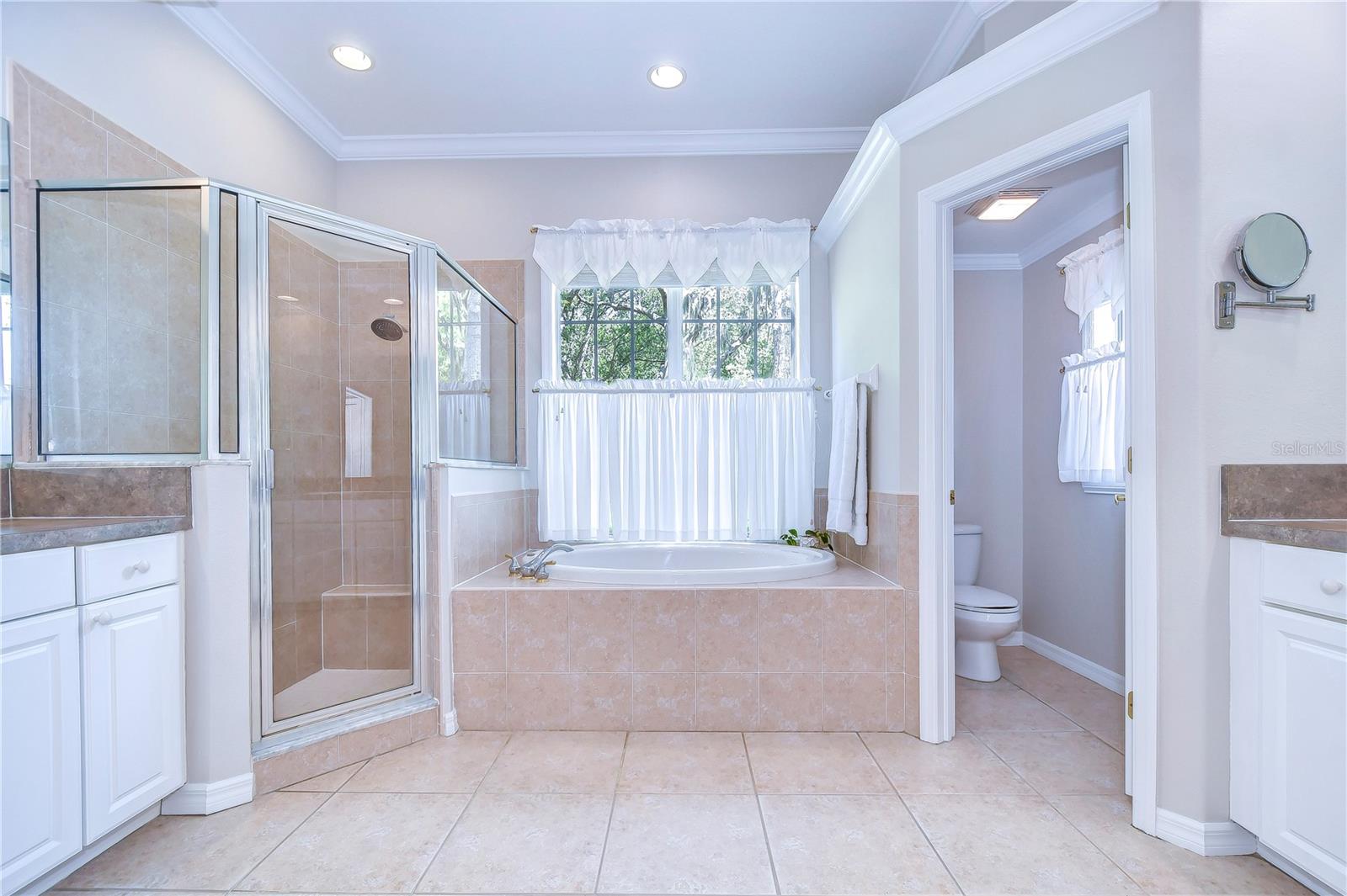 En-suite bathroom with separate vanities, jacuzzi tub, and a walk-in shower!