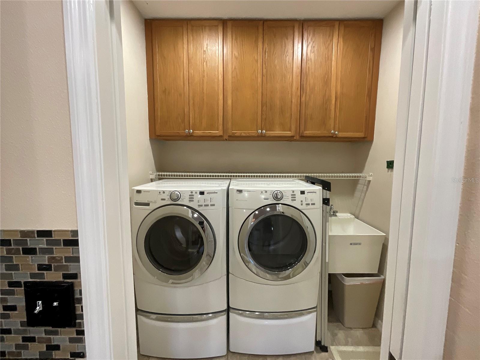 Laundry room with full size washer/dryer/sink located off kitchen