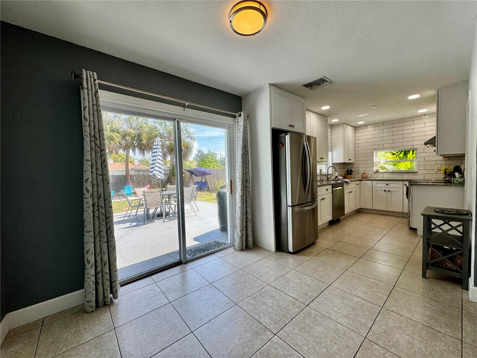 Bright kitchen with view of the yard from the window over the sink.