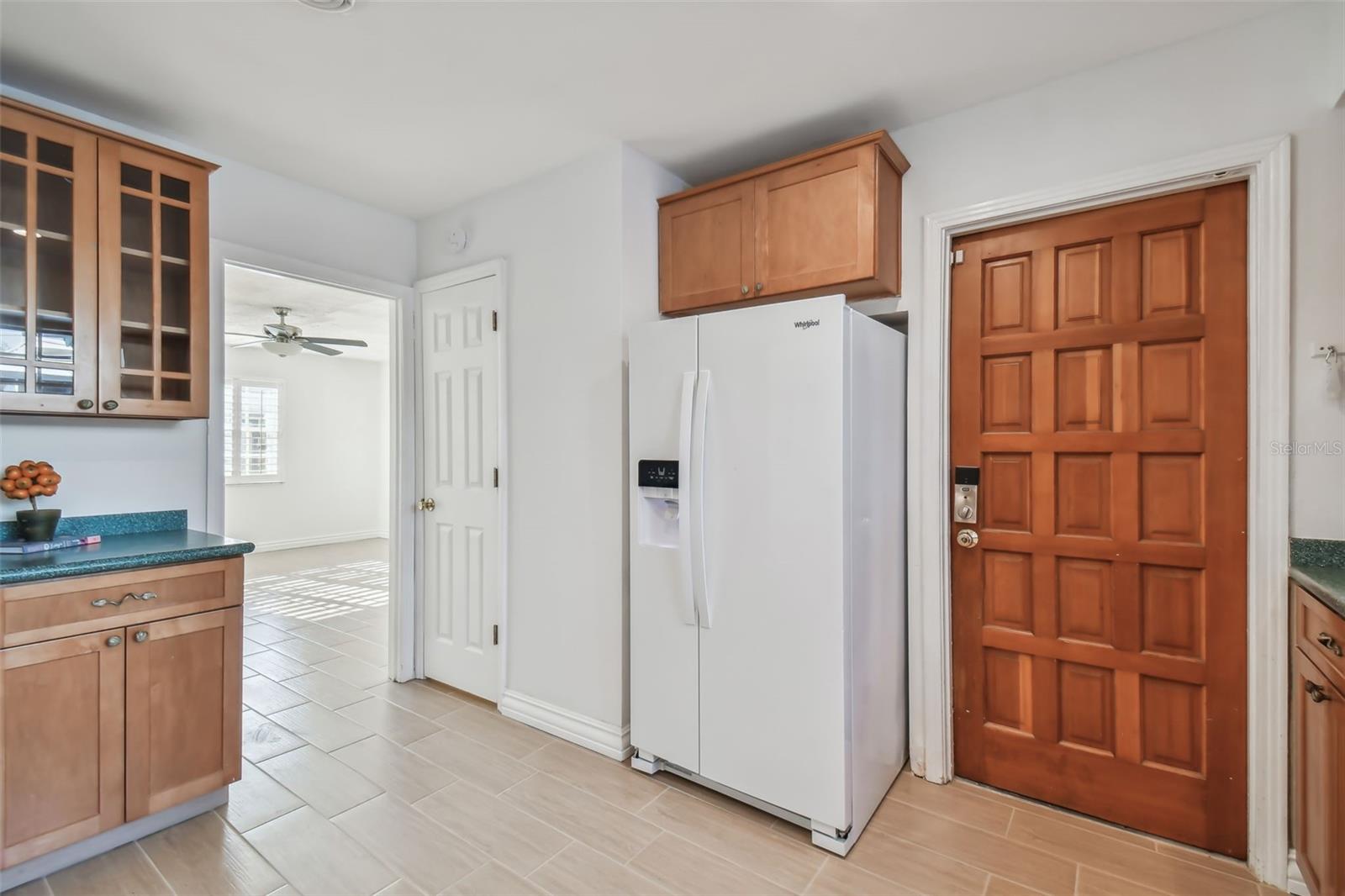 Kitchen has newer appliances and door to garage