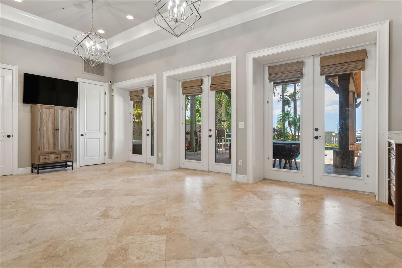 Formal dining with views of heated saltwater pool and Bay.