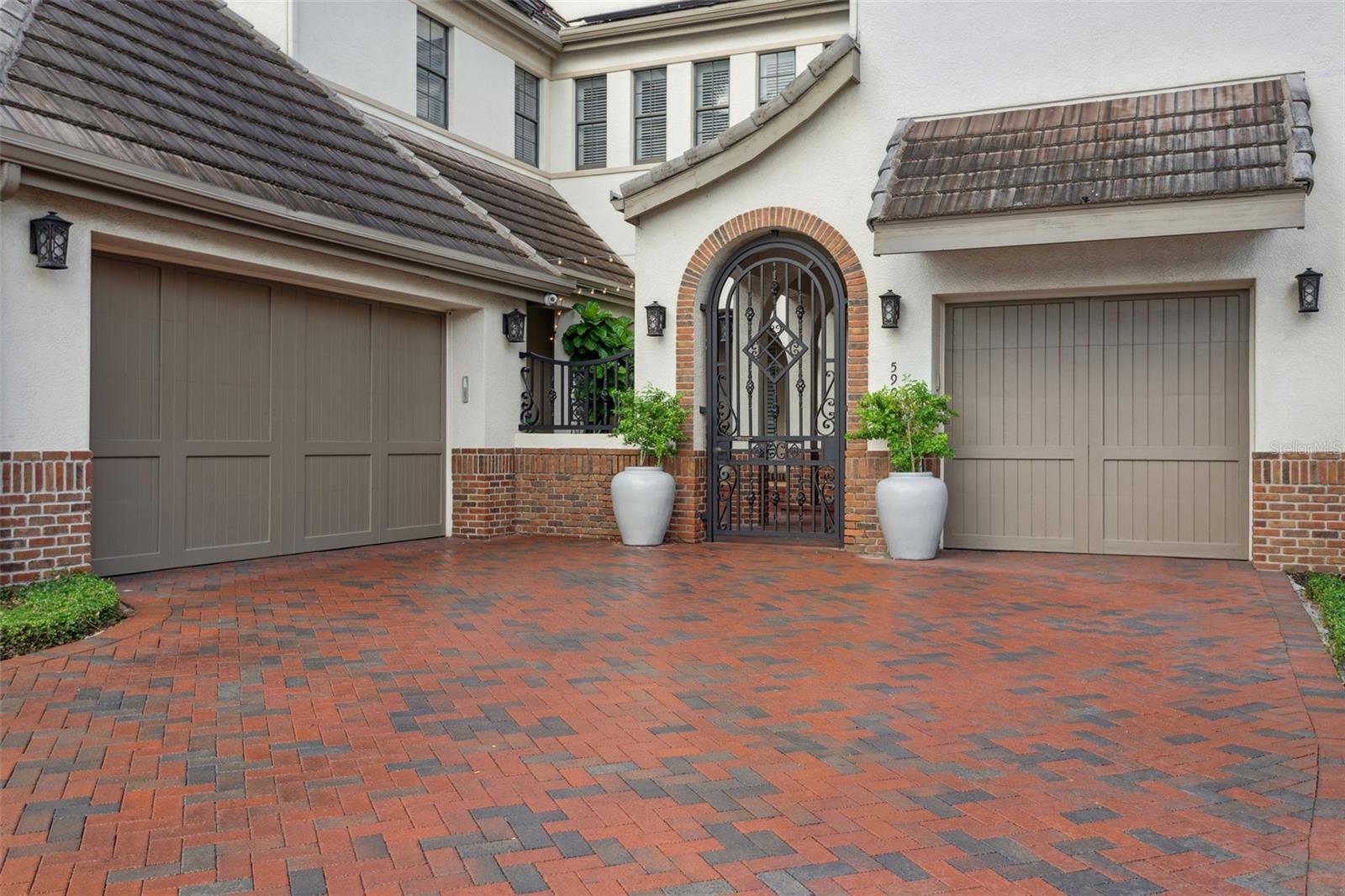2-car and 1-car garages flank a private courtyard.