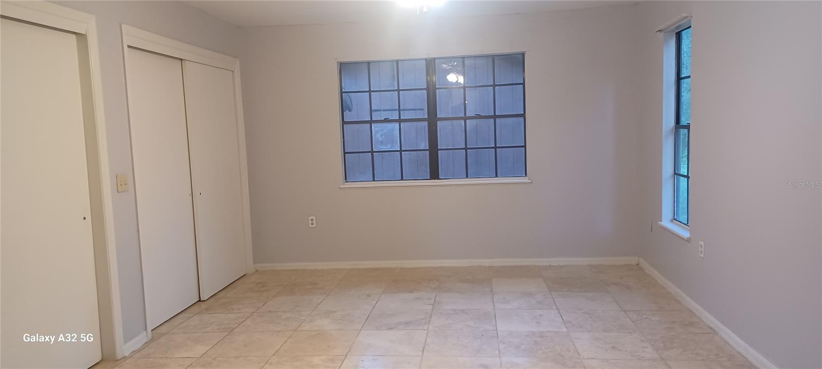 master bedroom with expensive travertine floor and 2 closets...