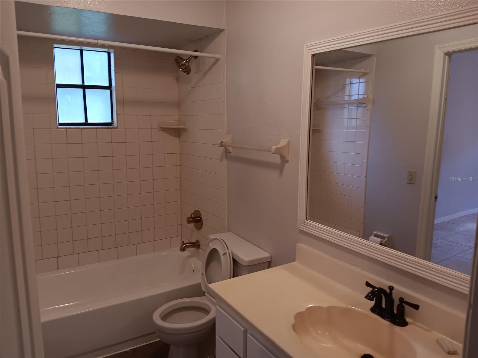bathroom with all new plumbing fixtures and framed mirror...