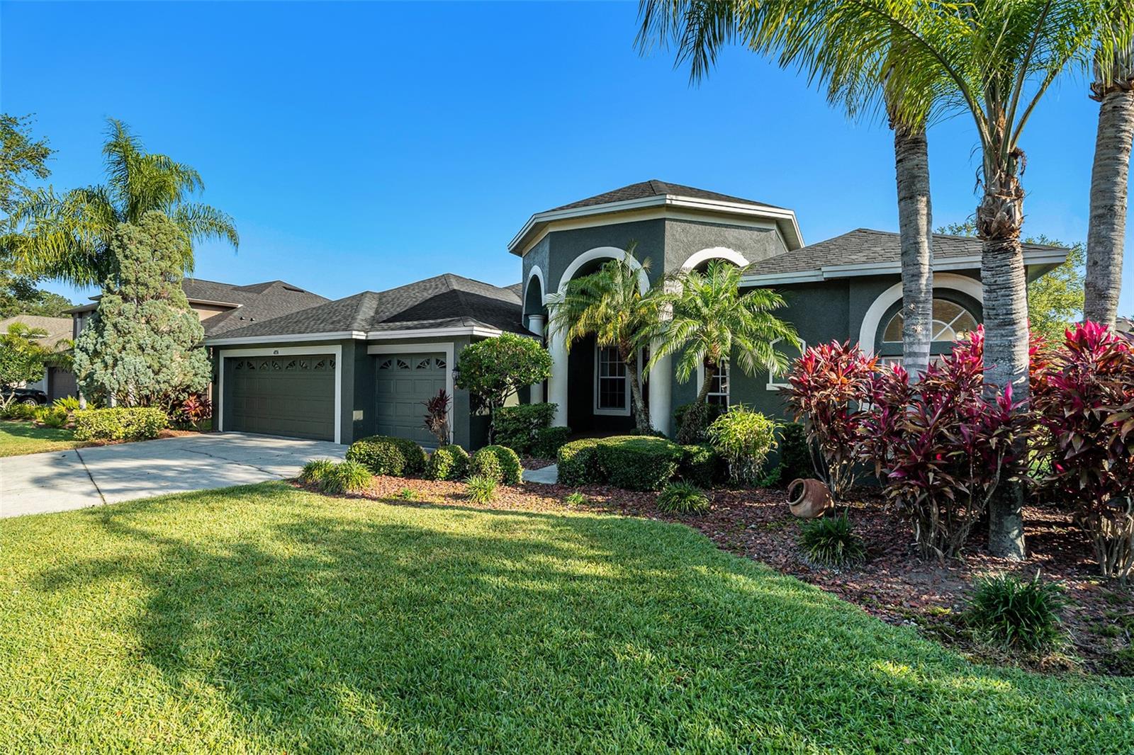 Front. One of a kind home with a beautiful partial pond view! Desirable GATED Lake Talia!