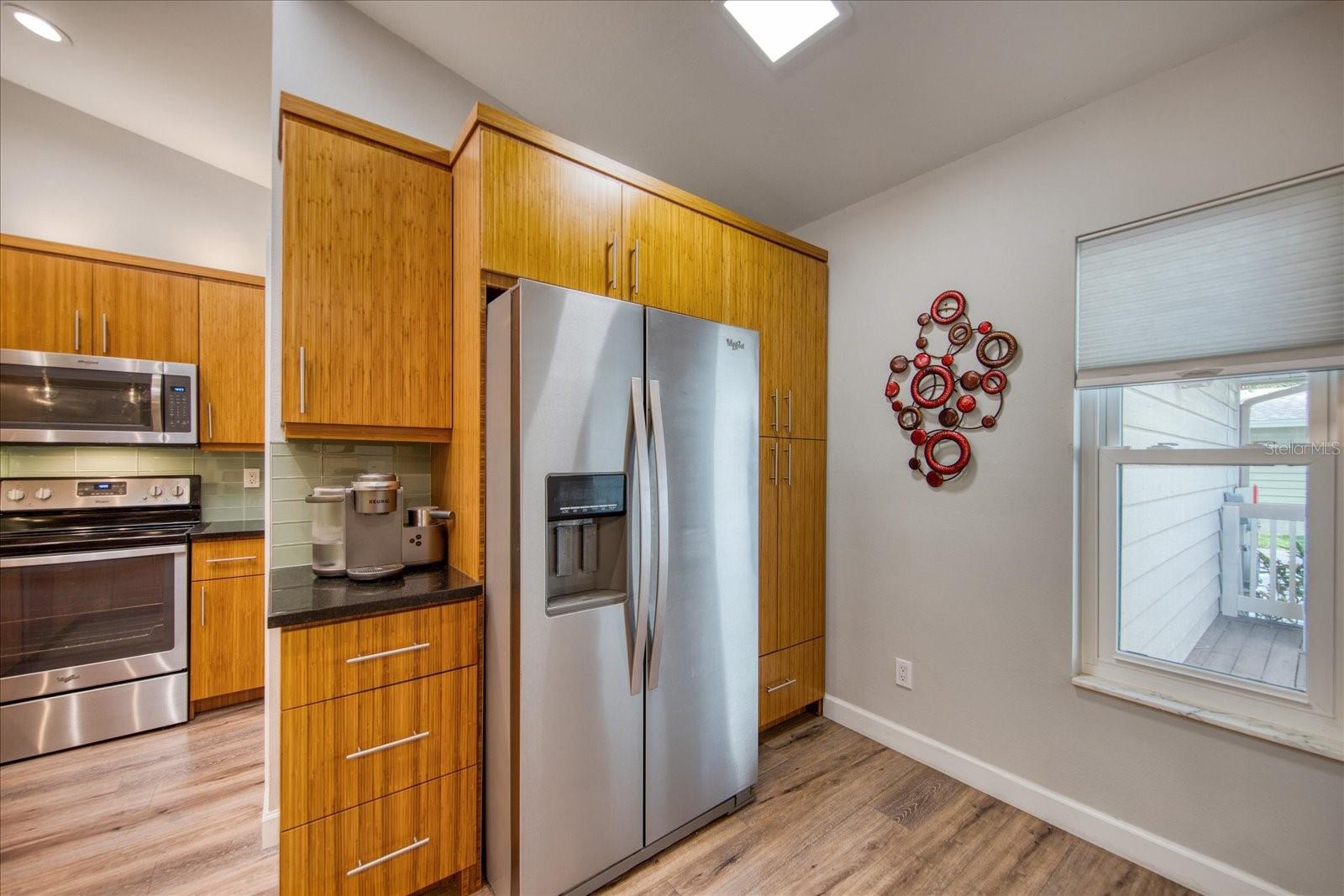 Cabinets to the right of the refrigerator are used as a pantry with pull-out shelves. The counter in this area is a perfect spot for your coffee station.