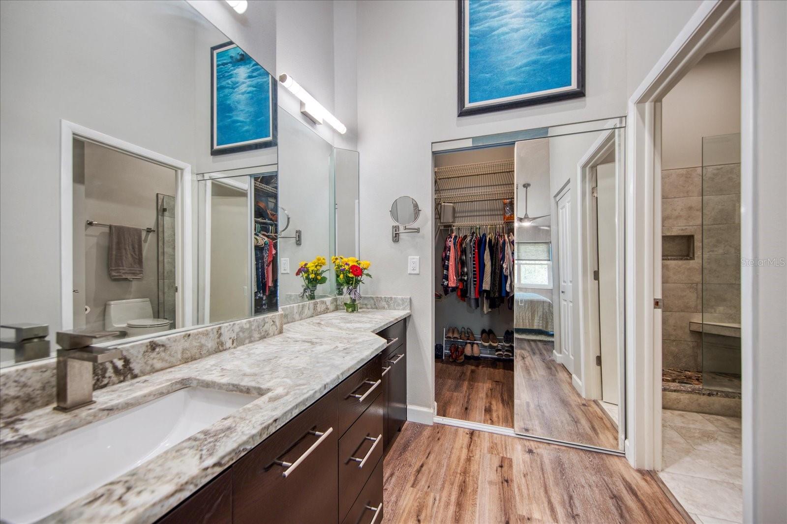 Remodeled Primary Bathroom with solid wood cabinets & granite countertops. The vanity has an abundance of storage space.