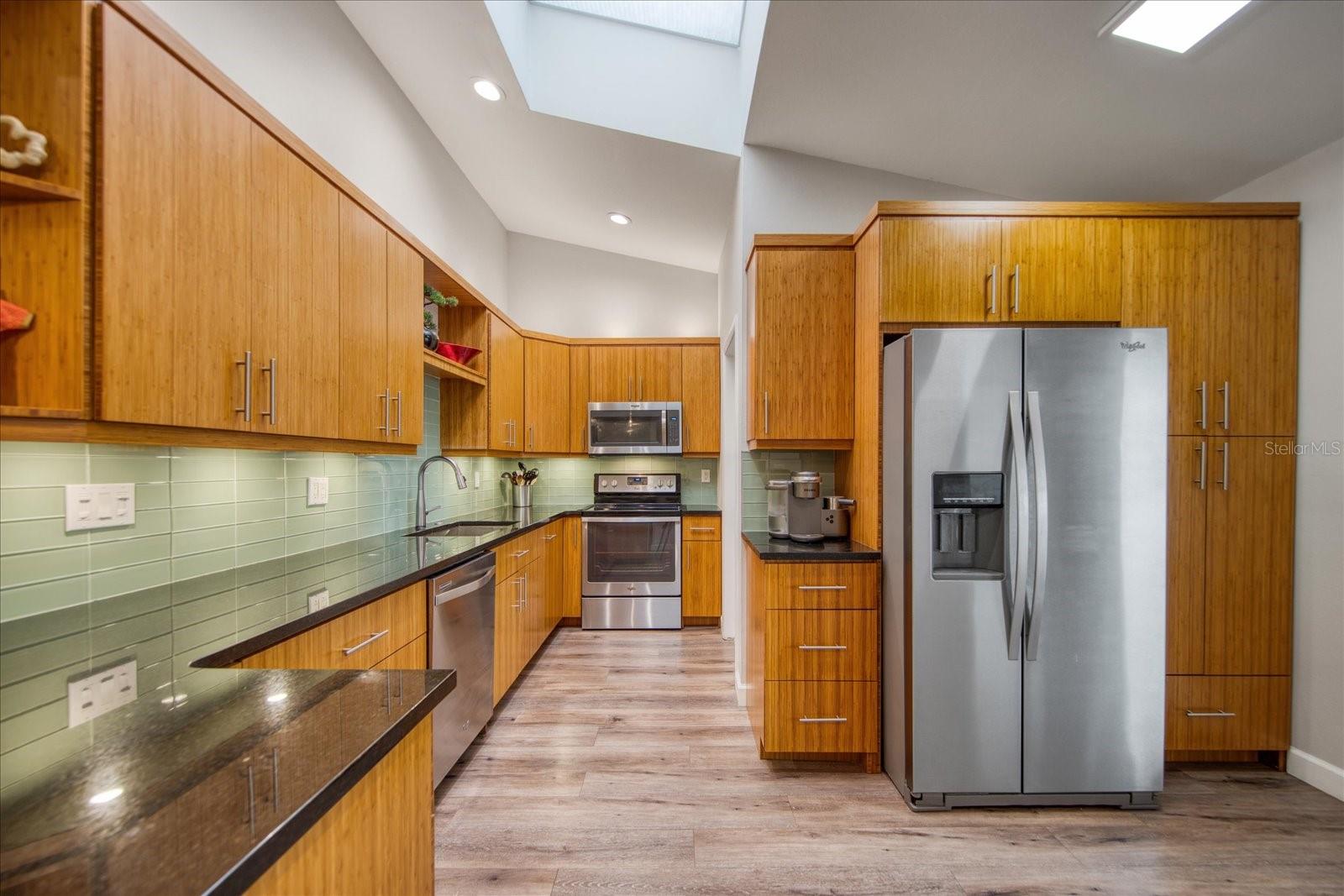 Newer stainless steel appliances, custom cabinetry with the soft-close feature on the drawers and cabinets, beautiful tile backsplash, USB outlets and dimmer switches--no detail overlooked.