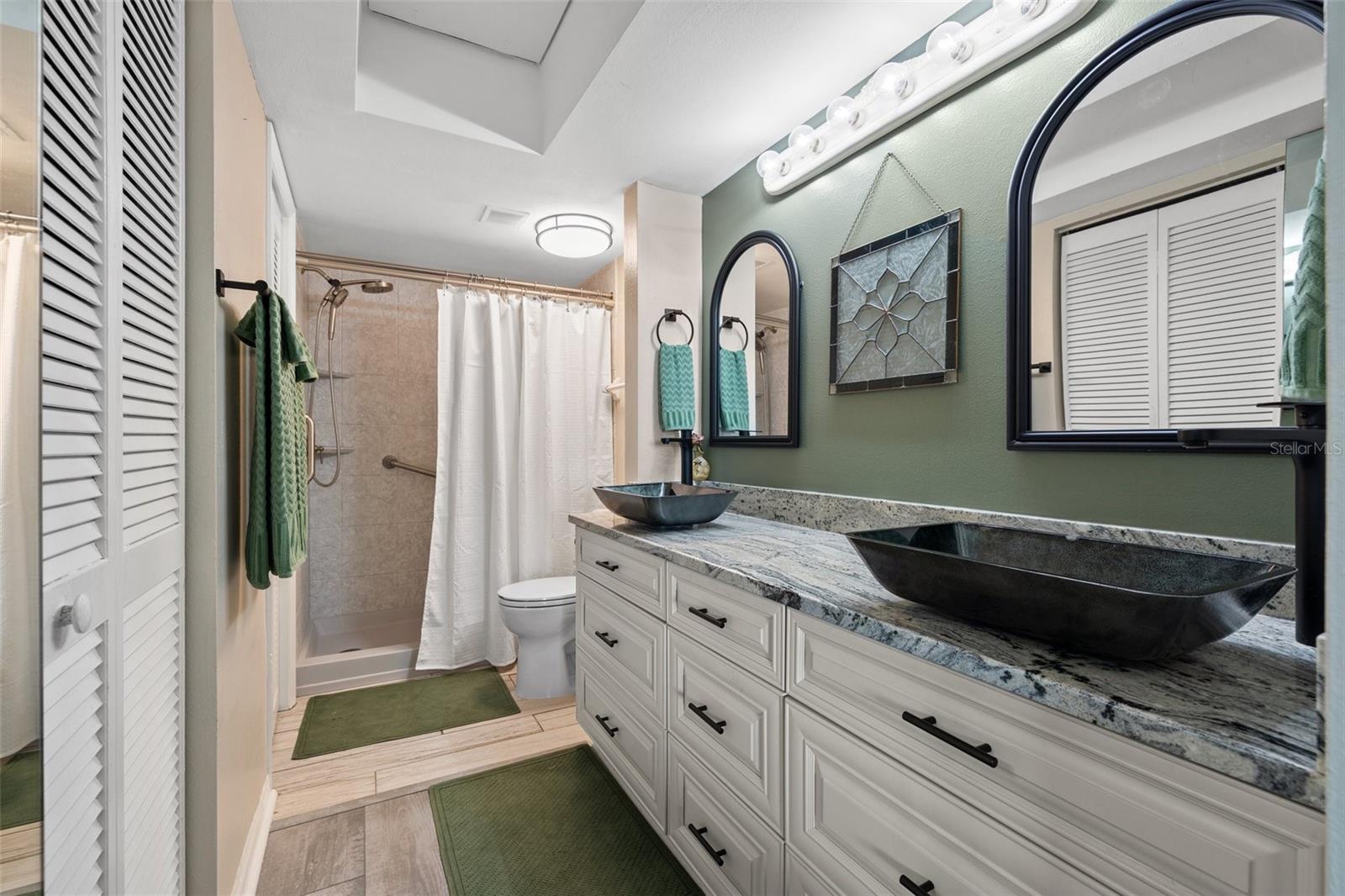 Primary ensuite bathroom with walk in shower and walk in closet!
