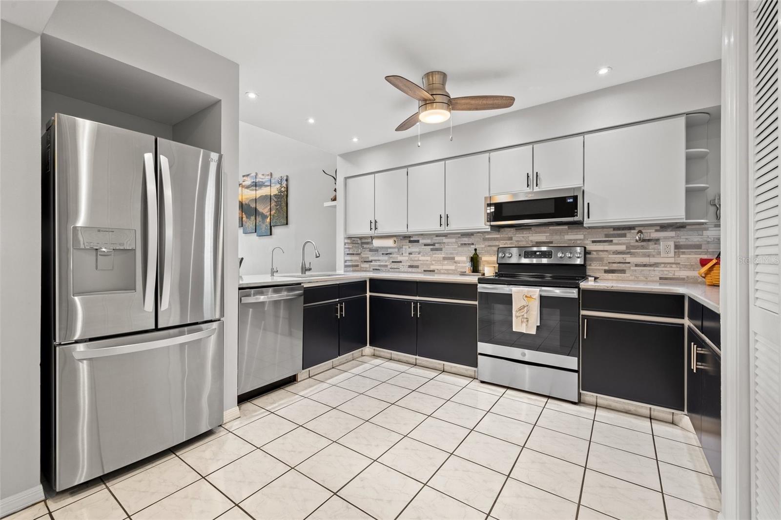 Beautifully updated kitchen with quartz countertops and stainless steel appliances.
