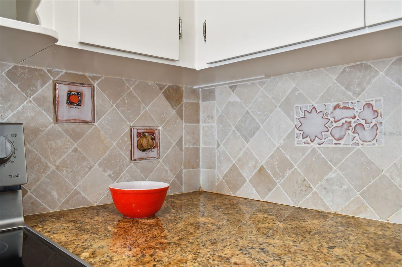 Artisan marble tile backsplash with custom handmade tile inserts