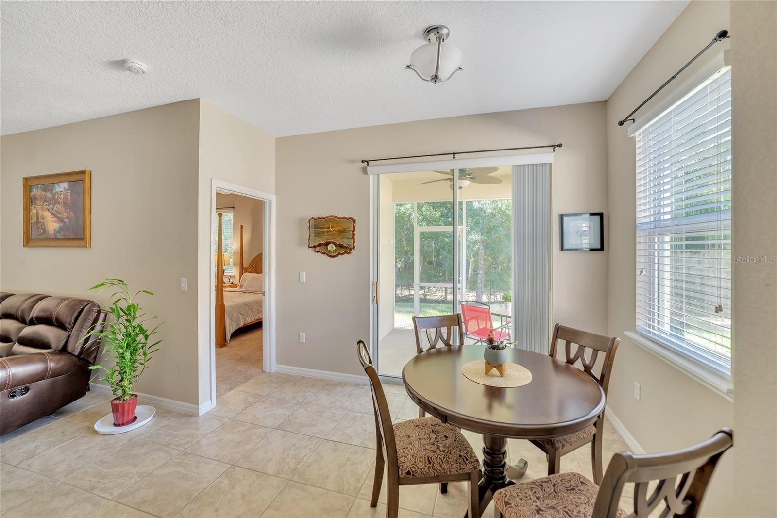 DINETTE AREA FEATURES ENTRANCE TO MASTER BEDROOM W/ENSUITE AND SGD TO SCREENED LANAI.