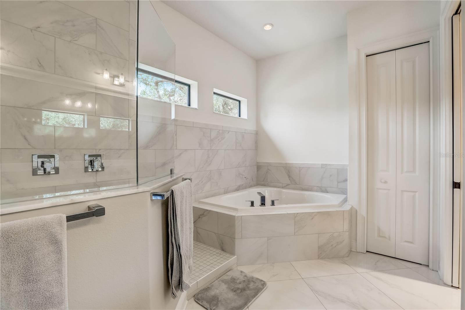 Owners suite bathroom with dual vanities, 2 person soaking tub and walk-in shower