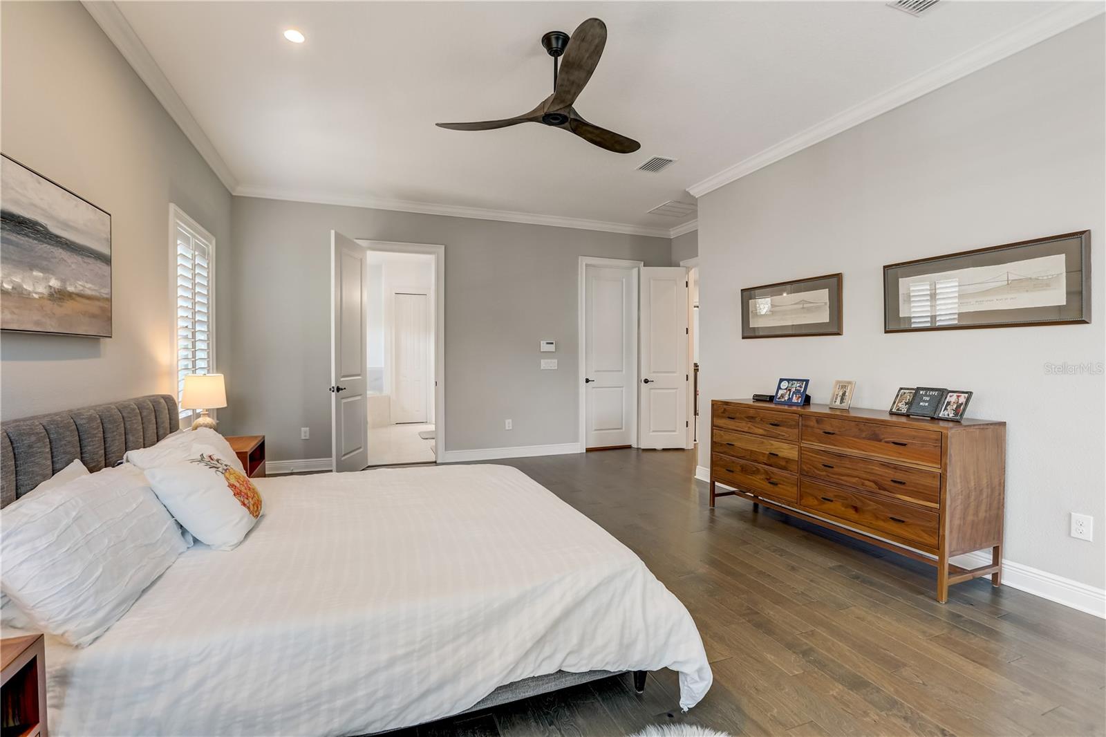 Owners suite bedroom, 2 walk-in closets, engineered hardwood floors, recessed lighting & ceiling fan