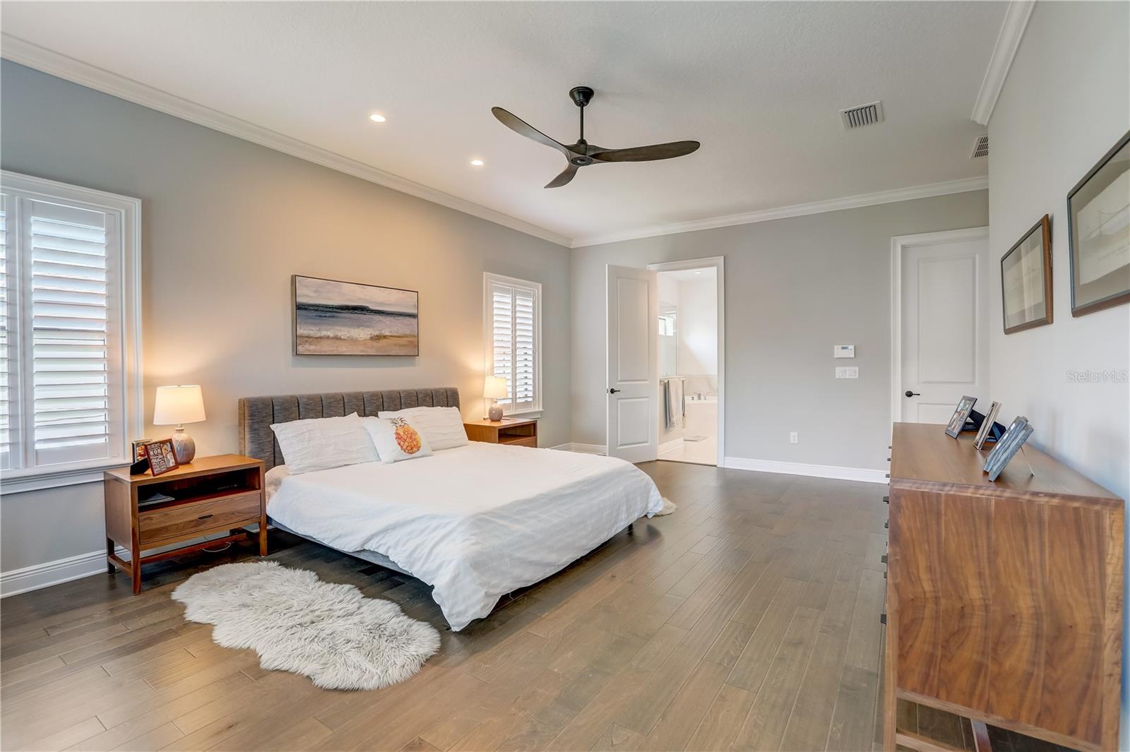 Owners suite bedroom, 2 walk-in closets, engineered hardwood floors, recessed lighting & ceiling fan