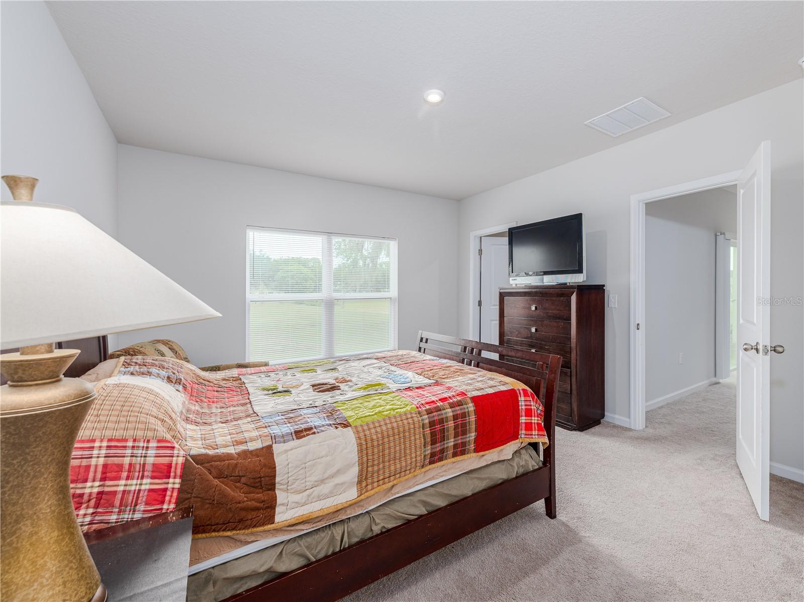 Large primary suite has a walk-in closet and bathroom.