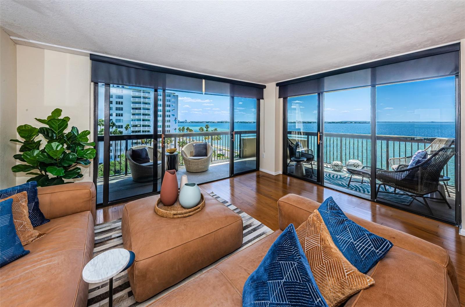 Floor to ceiling sliding glass doors lead to bay view balcony with spectacular sunrises.