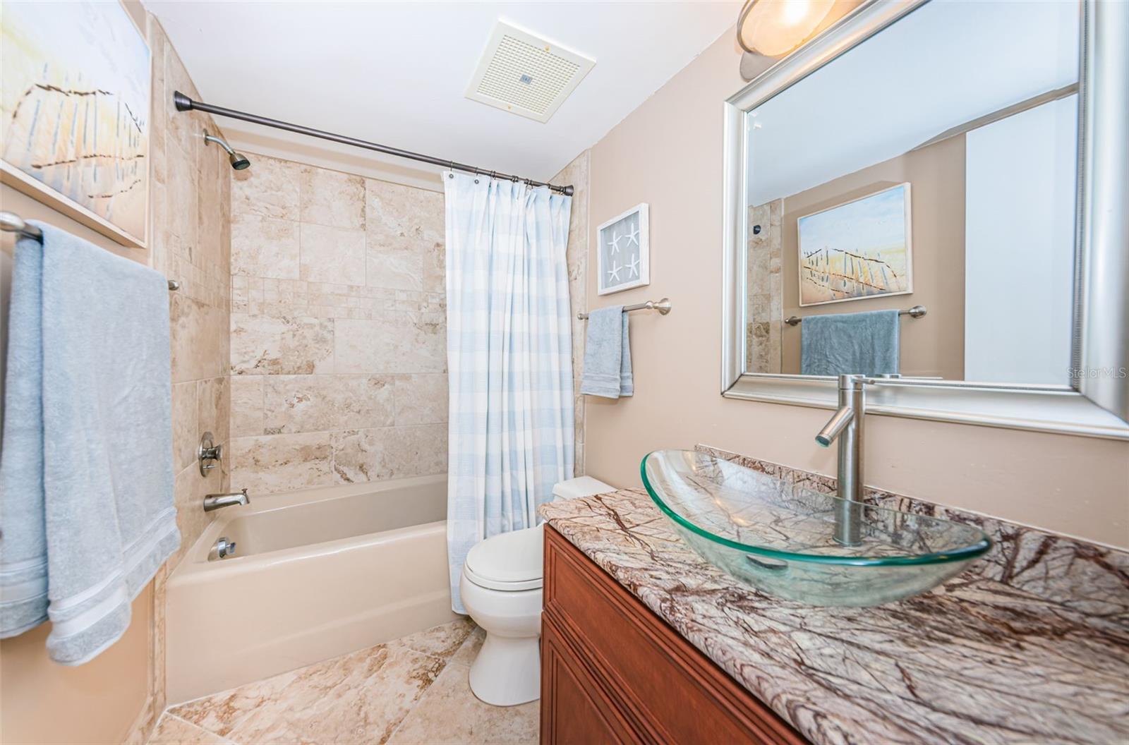 Full half bath with tub adjacent to guest bedroom.