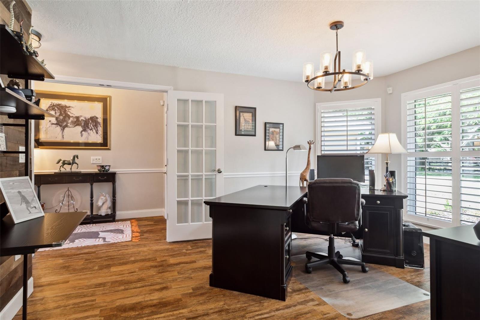 This room just off of the Foyer and adjacent to the Family Room is currently used as an office, but could be used as your formal dining room. Beautiful French doors and plantation shutters.